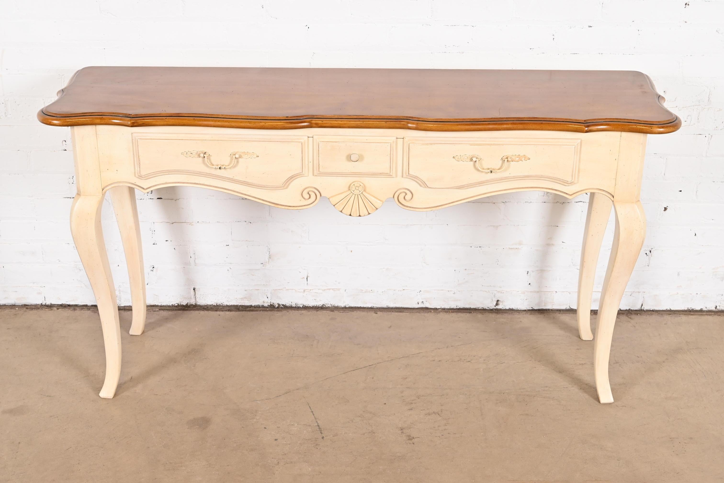 A gorgeous French Country Louis XV style three-drawer console table or sofa table

USA, Circa 1990s

White lacquered solid maple, with natural maple top.

Measures: 55.25