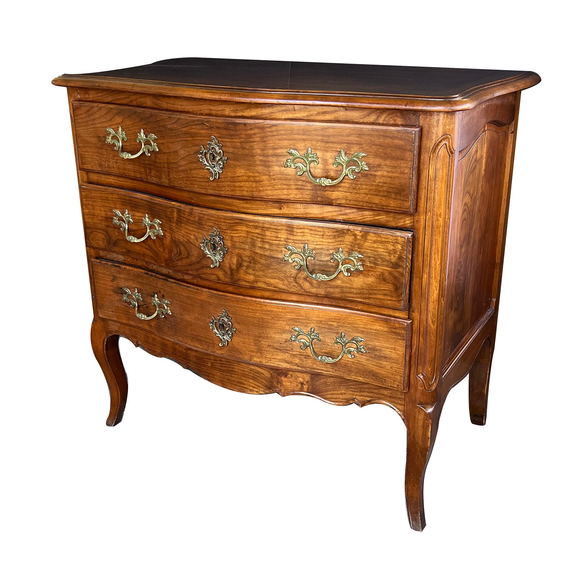 the arbalète-form top above a conforming body with 3 long drawers fitted with fine bronze pulls and escutcheons; over a shapely scalloped apron all raised on cabriole legs