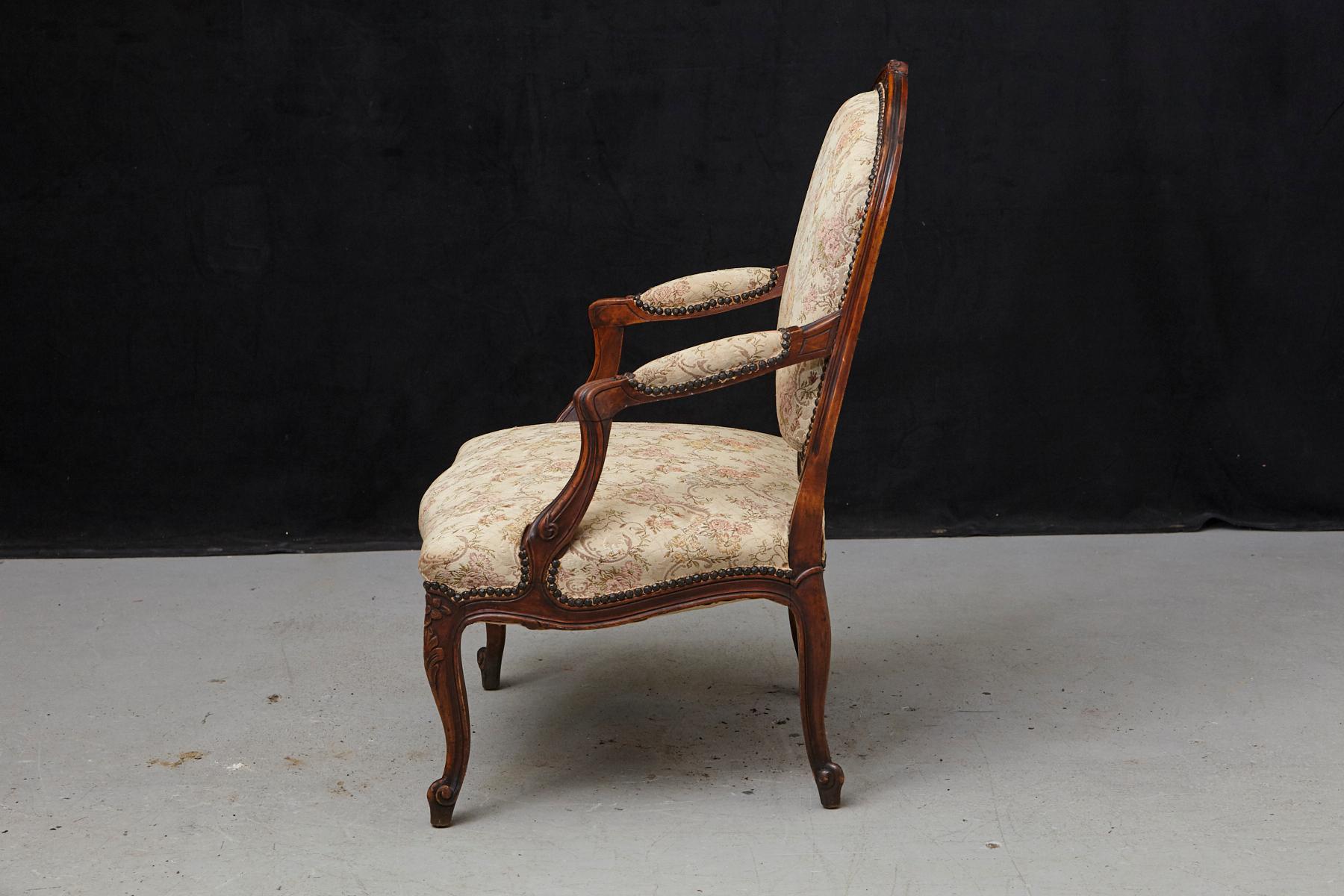 Brass French Provincial Louis XV Style Walnut Fauteuil with Nailhead Trim, circa 1930s For Sale