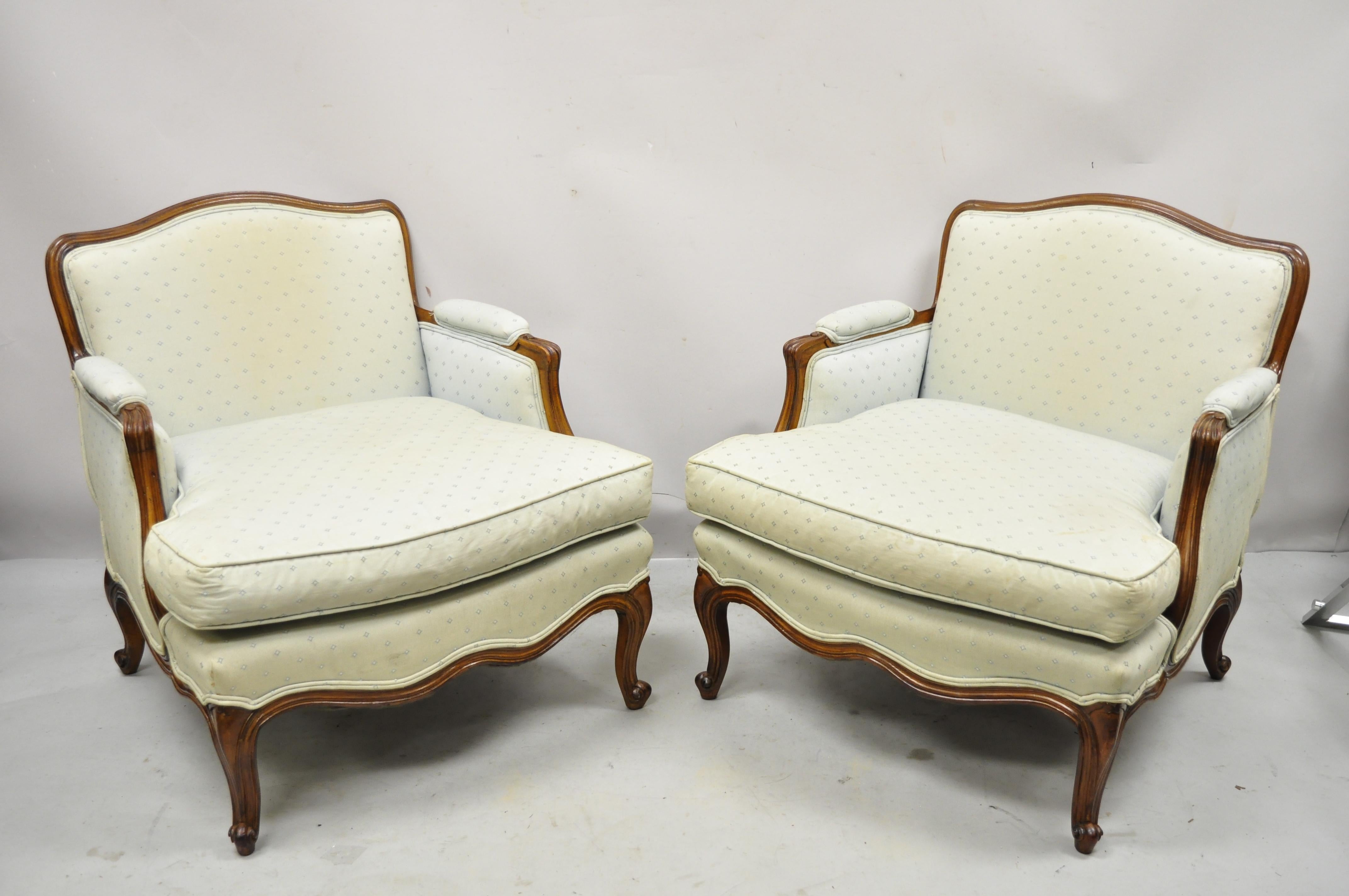 Vintage French Provincial Louis XV style upholstered bergere lounge club chairs and ottoman - 3 Piece Set. Item features (2) lounge chairs, (1) ottoman, solid wood frames, beautiful wood grain, upholstered armrests, distressed finish, nicely carved