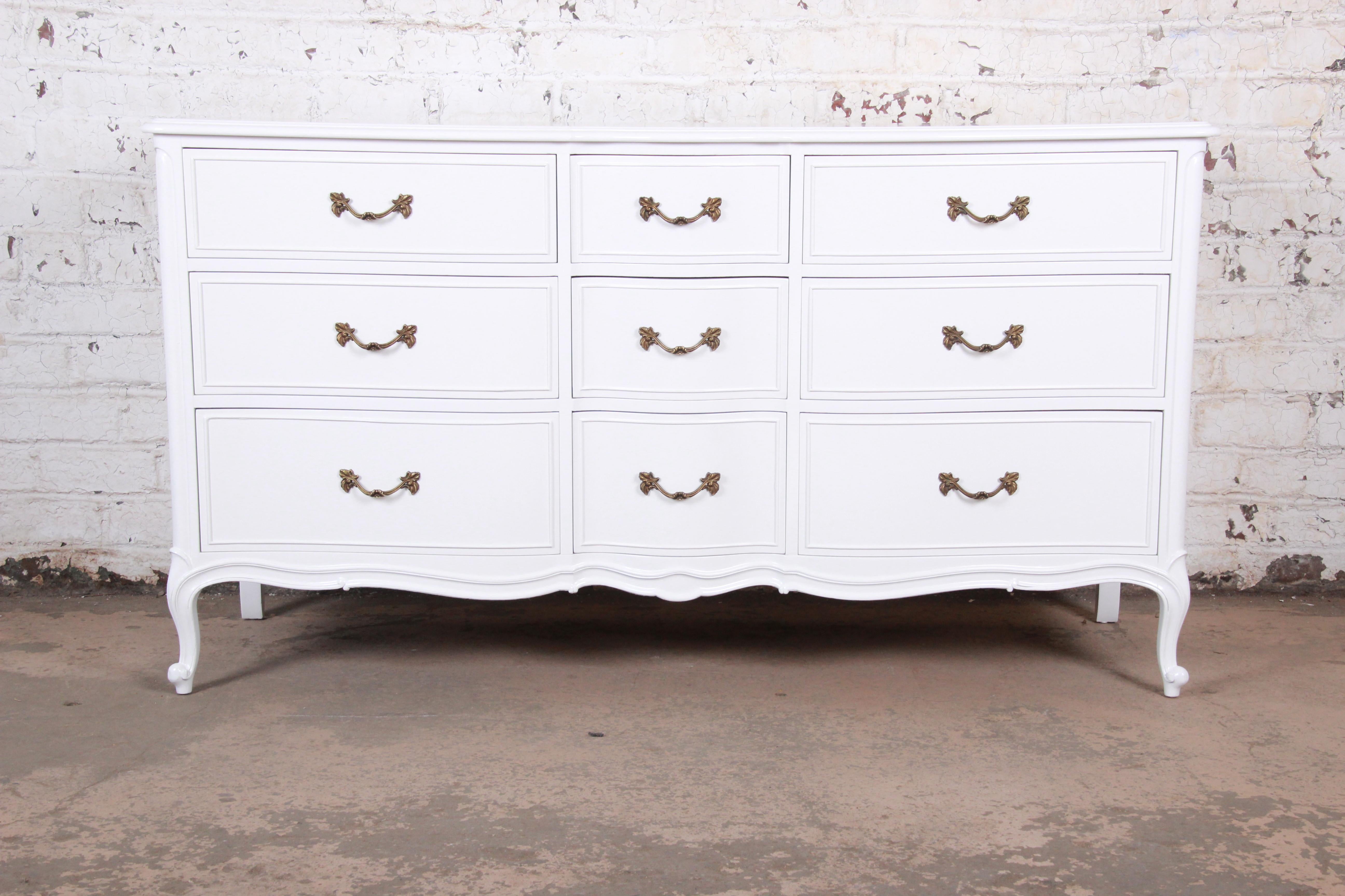 A gorgeous French Provincial Louis XV style white lacquered triple dresser or credenza

By Drexel Furniture

USA, circa 1950s

White lacquered walnut, with original brass hardware.

Measures: 64.25
