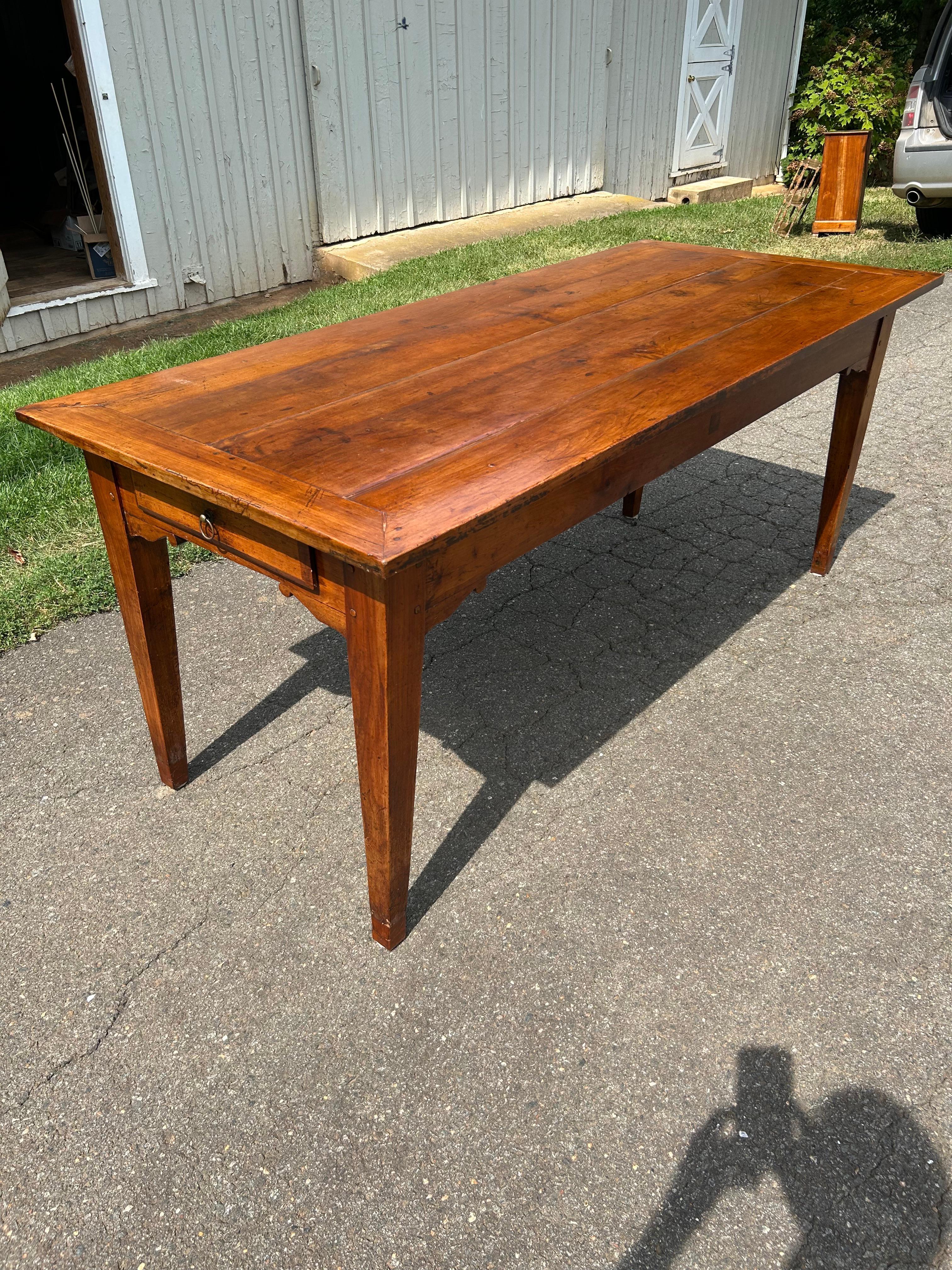French Provincial Louis XVI style Farm Table. Wonderful proportions with a paneled top, single drawer with shaped aprons over straight tapering legs. Made of Wild cherry with a beautiful Lustrous Color and Rich Patination.  Normandy Circa 1830.
