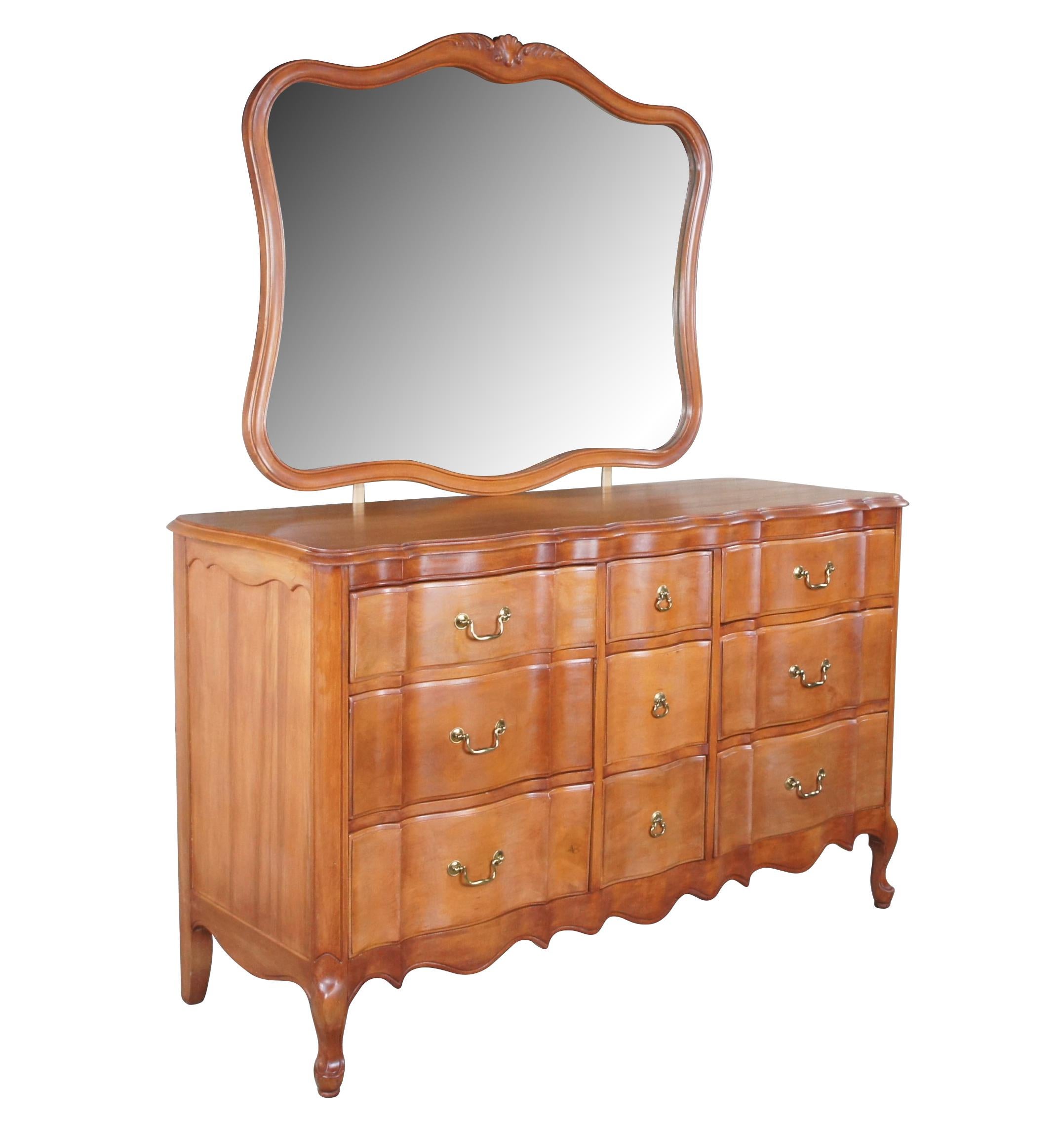 Mid century French Provincial dresser or chest of drawers with mirror.  Made of mahogany featuring serpentine form with nine drawers, brass hardware, cabriole legs and  shell accent mirror .

Dimensions: 
58