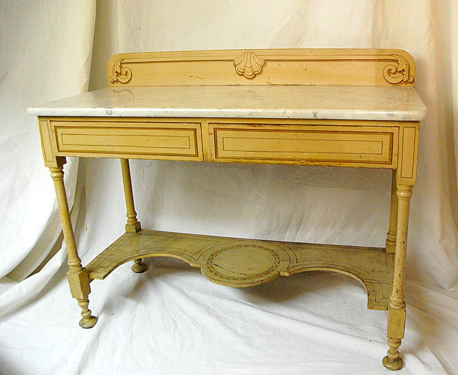 French Provincial mid-19th century painted two-drawer marble top server with shaped lower shelf. This handsome multipurpose table has its original decoration with shell, scroll and line detailing. The paint has some flaking and wear as one would