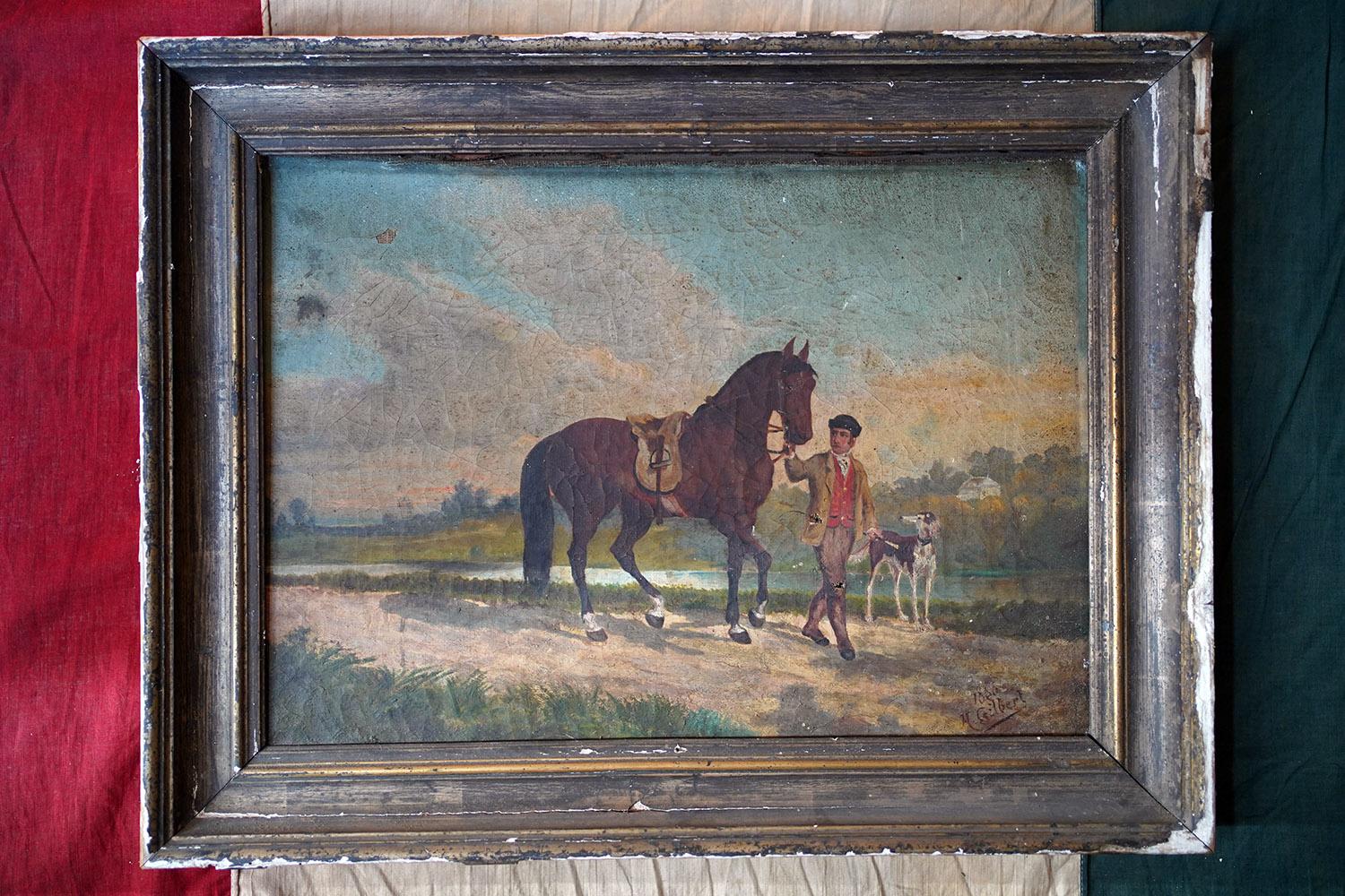 In entirely original condition, the provincial oil on canvas painting of a youth with a stallion and hunting dog amidst classic rural French countryside walking upon a track by a river side, painted in the naïve style by a journeying Englishman, and