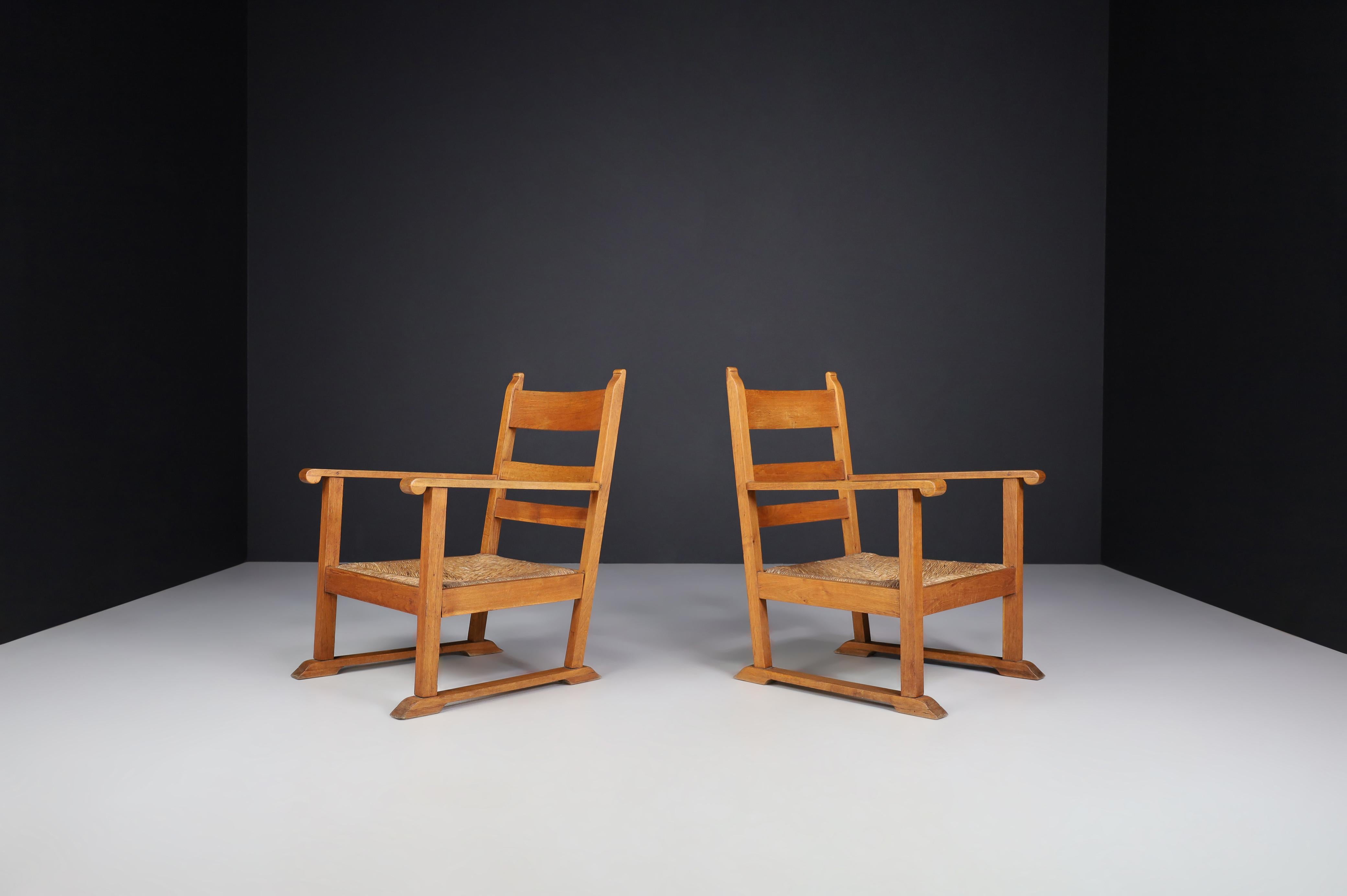 French Provincial Oak and Rush Armchairs, France, 1950s

Upgrade your living space with this enchanting set of two rustic armchairs, each a stunning example of Mid-20th-century French design from the 1950s. With their intricate craftsmanship and