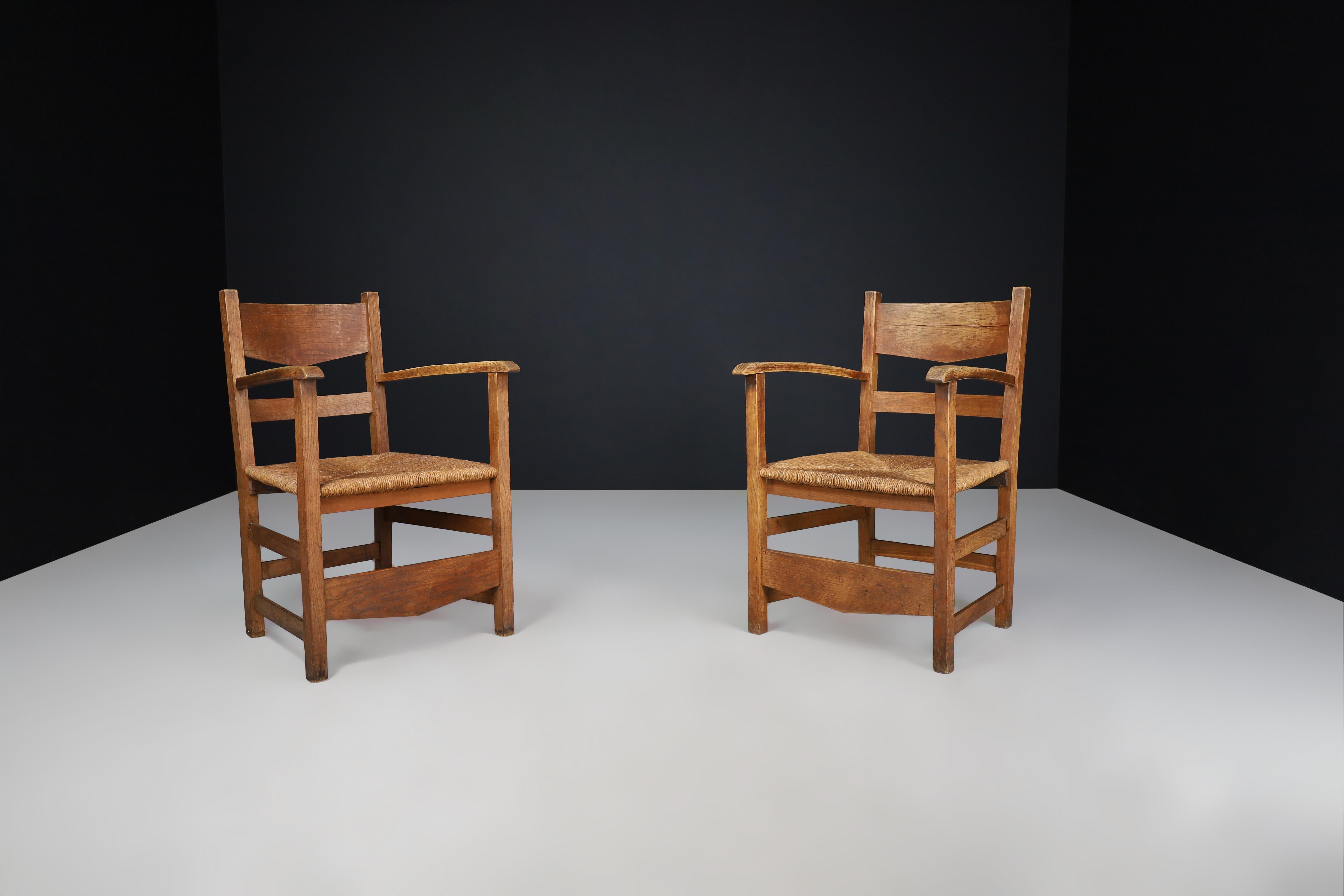 French Provincial Oak and Rush Armchairs, France 1950s

Transform your living space with this delightful set of two rustic armchairs, reflecting the elegant charm of Mid-20th-century French design from the 1950s. Each chair is crafted with