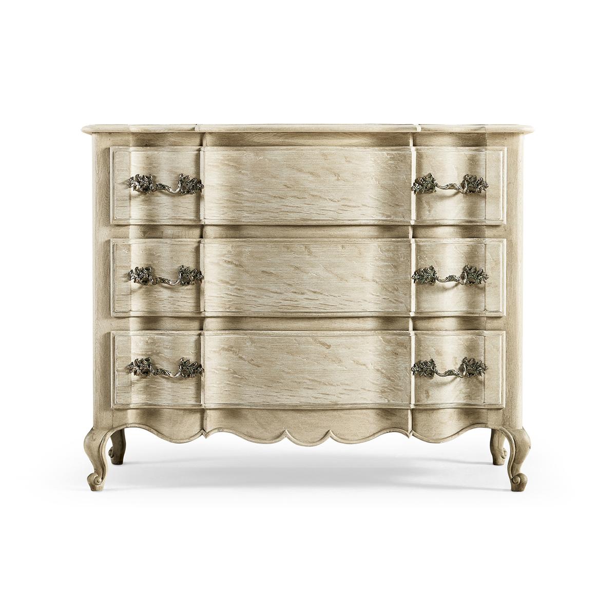 French Provincial Oak Commode, a solid stripped oak case featuring three serpentine front drawers and a hand-carved skirt on delicate cabriole legs.

Dimensions: 42