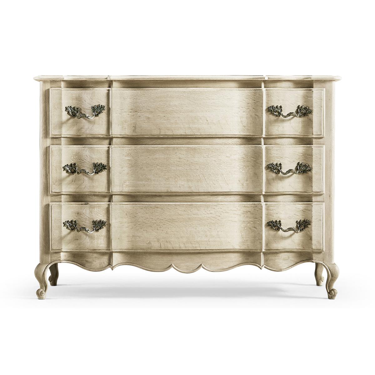French Provincial Oak Commode, a solid stripped oak case featuring three serpentine front drawers and a hand-carved skirt on delicate cabriole legs.

Dimensions: 50