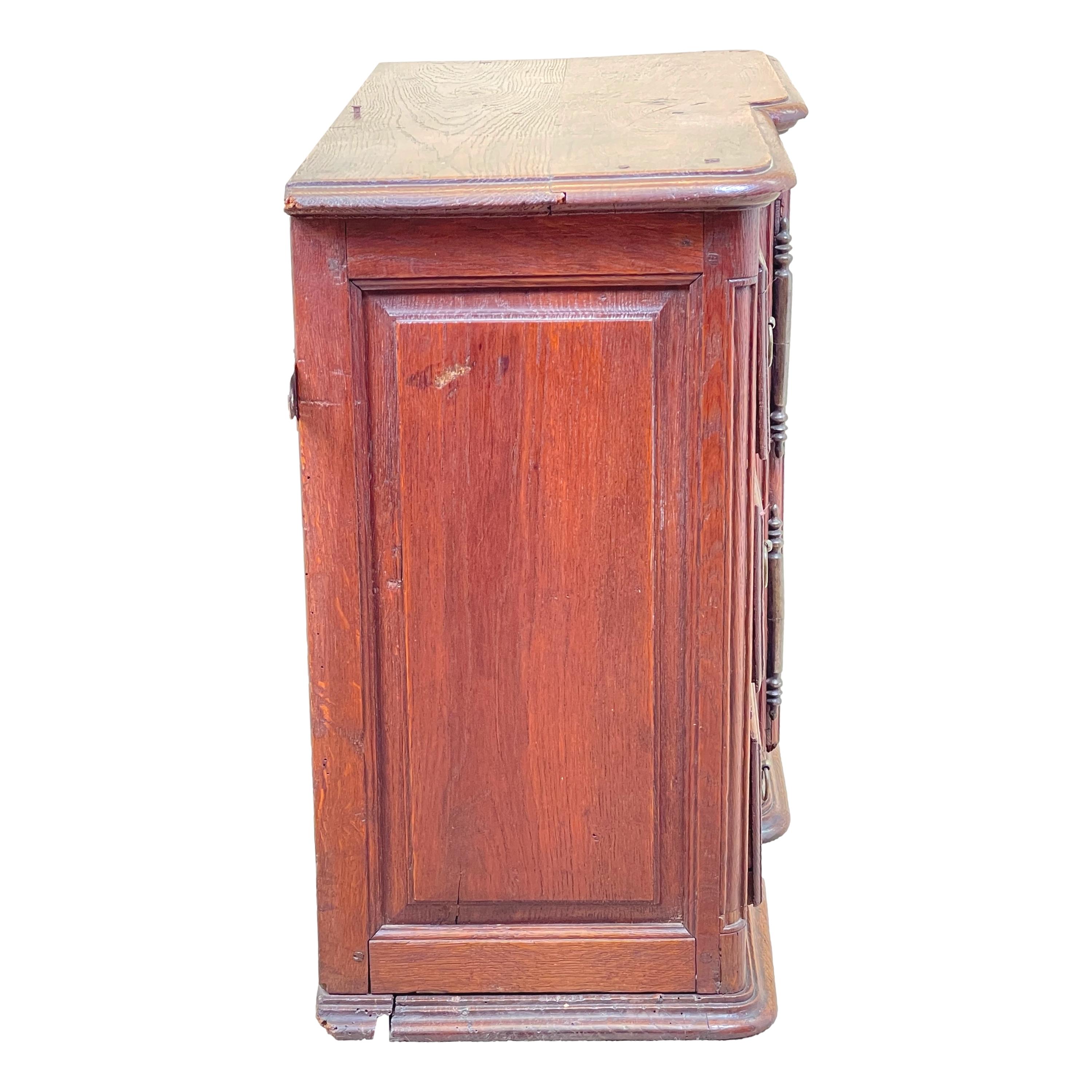 A rare mid 19th century french oak wall hanging cupboard, of unusual design and real charm, with arched panelled door alonside three panelled drawers.


This charming mid 19th century French provincial wall hanging cupboard really is quite