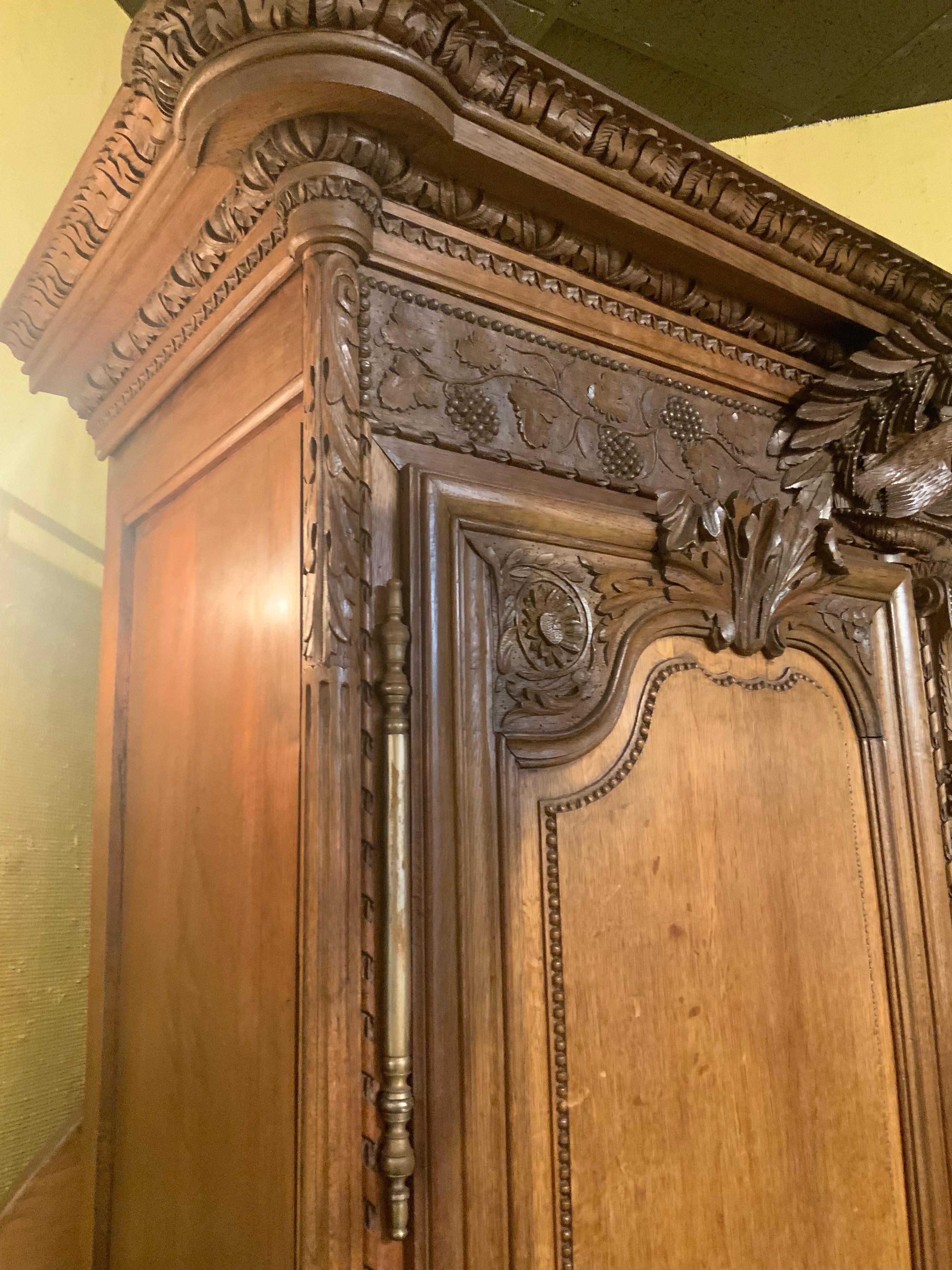 French provincial oak wedding armoire. 19 th c. With carved love birds In Excellent Condition In Houston, TX