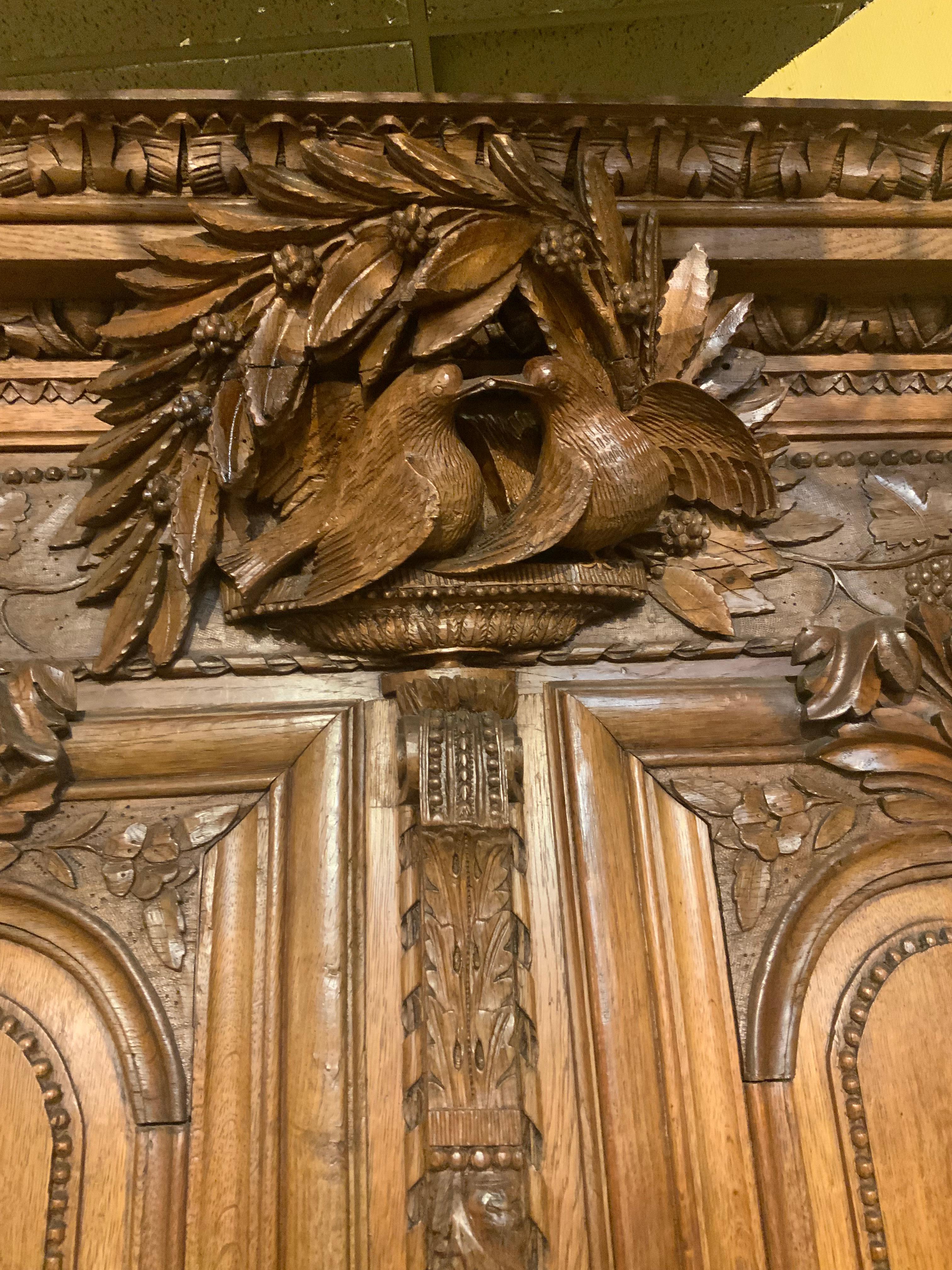 19th Century French provincial oak wedding armoire. 19 th c. With carved love birds