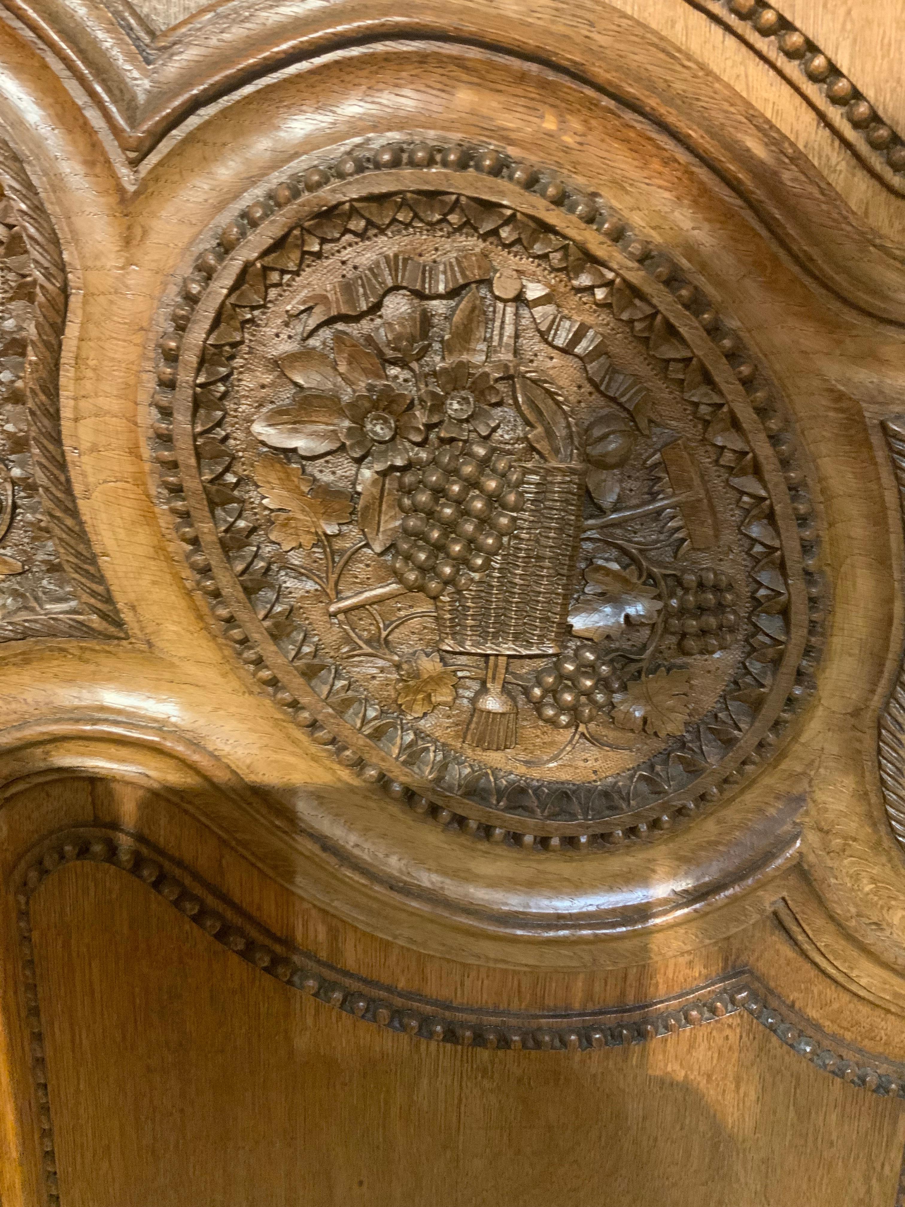 Oak French provincial oak wedding armoire. 19 th c. With carved love birds