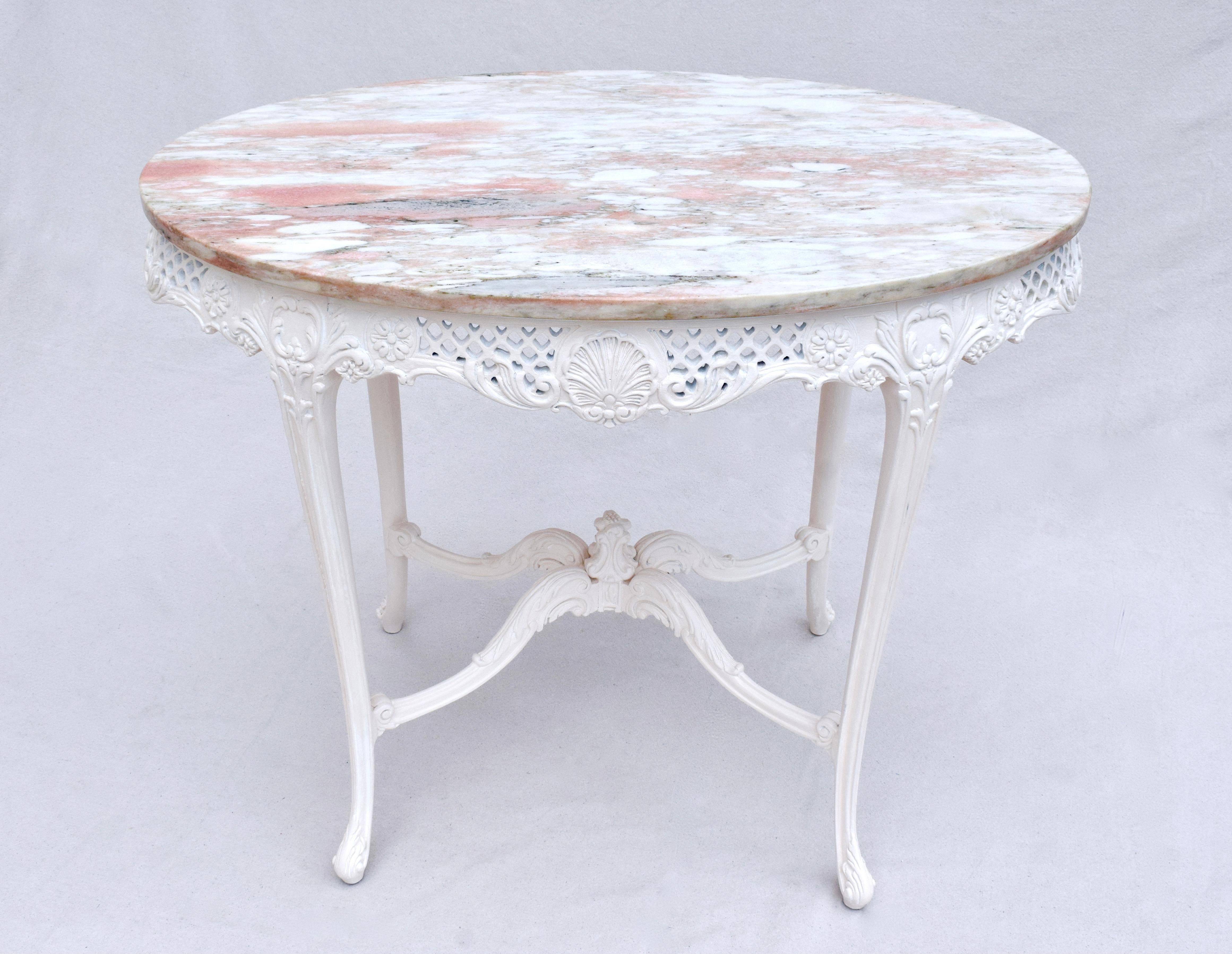 1950's vintage French Provincial style pink Arabascato marble top, side or center table with Rocaille shell carvings, pierced detailing & ornate stretcher base with decorative finial. Custom painted in soft pink, nearly white. 