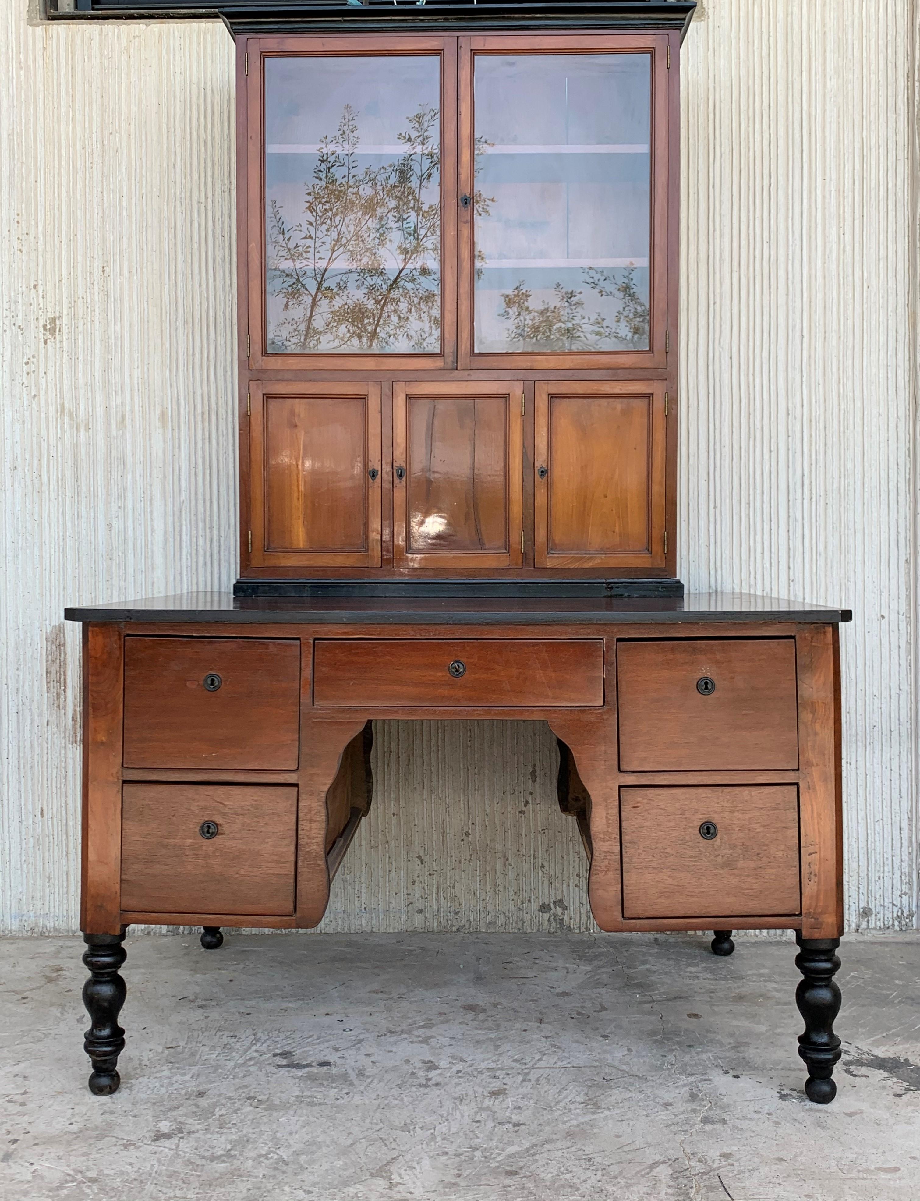 This early (circa 1830) French Provincial plantation style walnut secretary desk and bookcase features an upper part topped by a cornice above two glazed doors opening up to a shelved interior great for either books or display. An open center