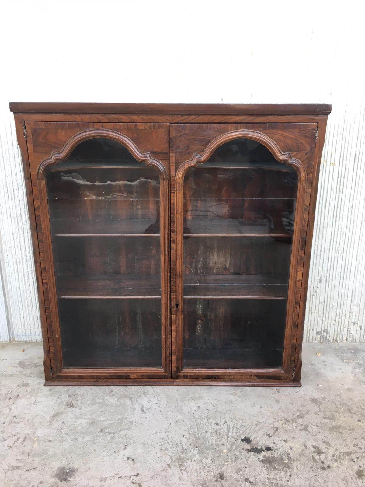 This early (circa 1830) French Provincial plantation style walnut bookcase features an upper part topped by a cornice above two glazed doors opening up to a shelved interior great for either books or display.
 
   