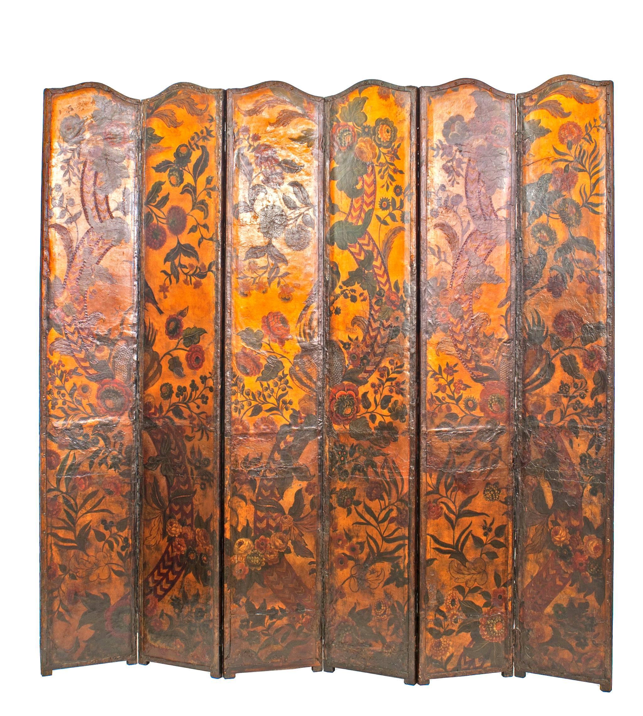 French Provincial Renaissance style (possibly 17th Century) leather mounted 6 panel screen with a gold background and decorated with painted parrots and foliage.
 
