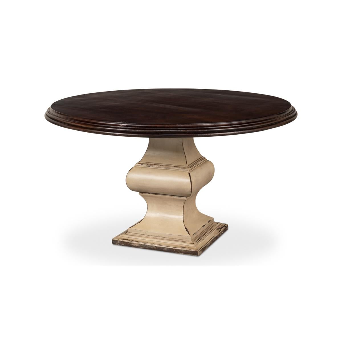 French Provincial round dining table with a dark stained round top on a strong architectural pedestal base with an antiqued cream-painted finish. The warm earth tones of this special dining table allow it to be the star of any dining area or the