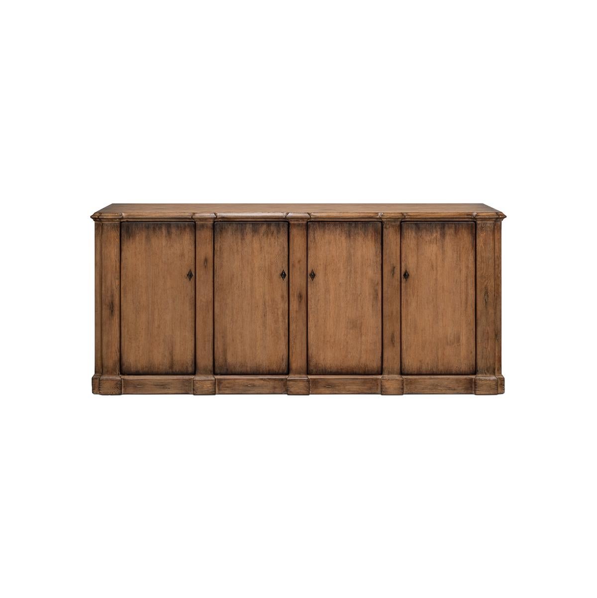 This piece captures the romantic essence of country style with its rich, warm wood finish and classic design. The sideboard's generous length, accented by four doors that open to a fitted interior with removable shelves, offers substantial storage