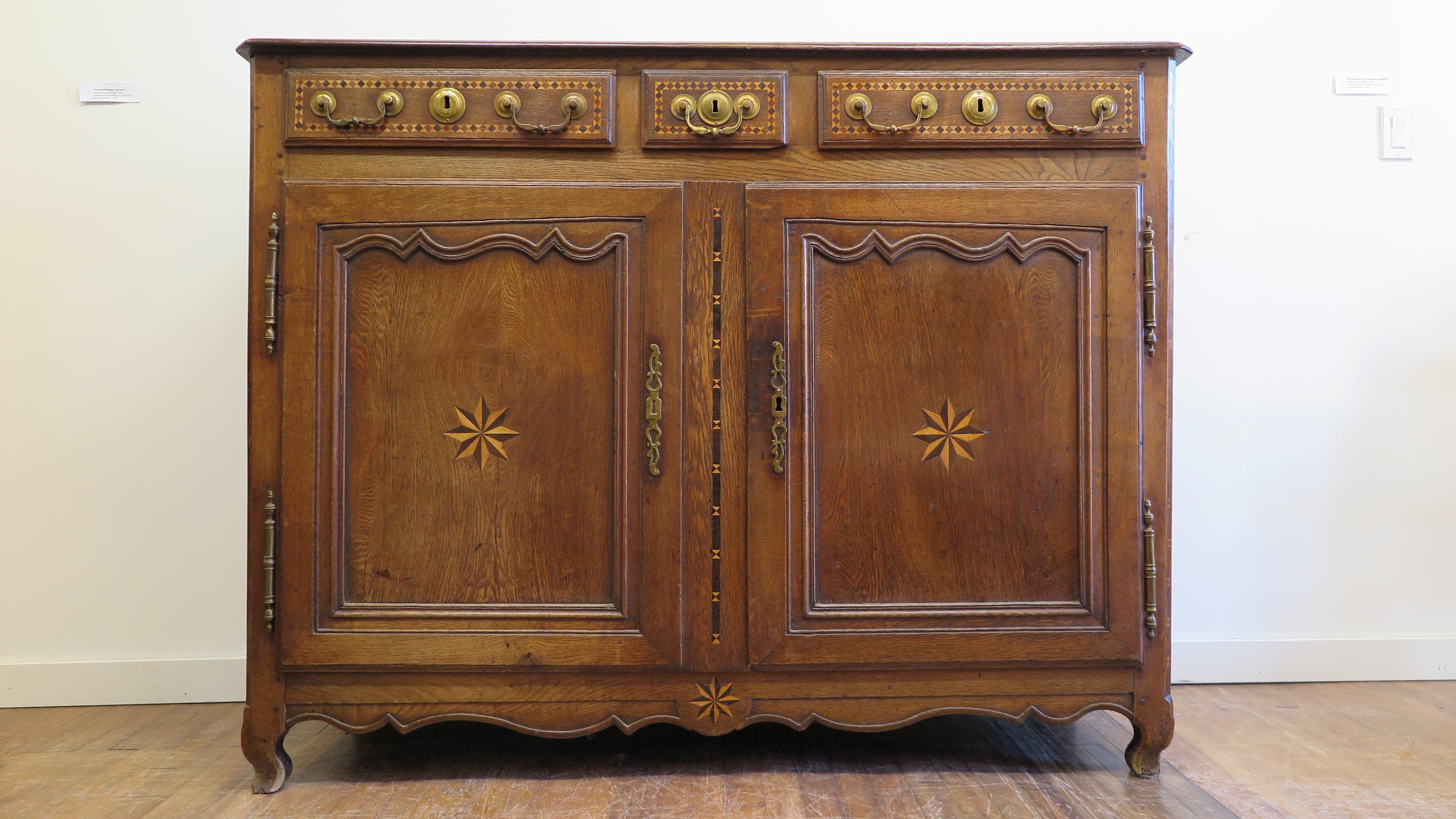 19th century French Provincial sideboard. French credenza walnut and oak with fruit wood inlay, and brass hardware. Excellent Marquetry inlay work throughout the piece. Another detail of hand made craftsmanship notice the angle of the inside panel