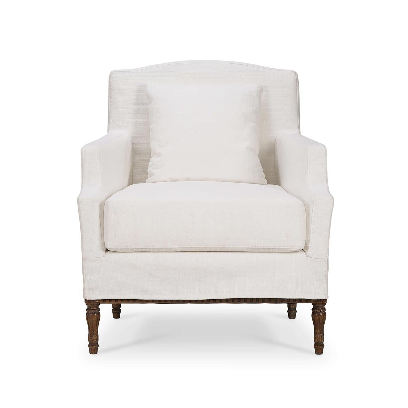 An exquisite blend of timeless elegance and modern comfort. This charming armchair features a sleek slipcover design in premium arctic white performance fabric, exuding sophistication and style. The intricate Neo Classic style carved wooden legs