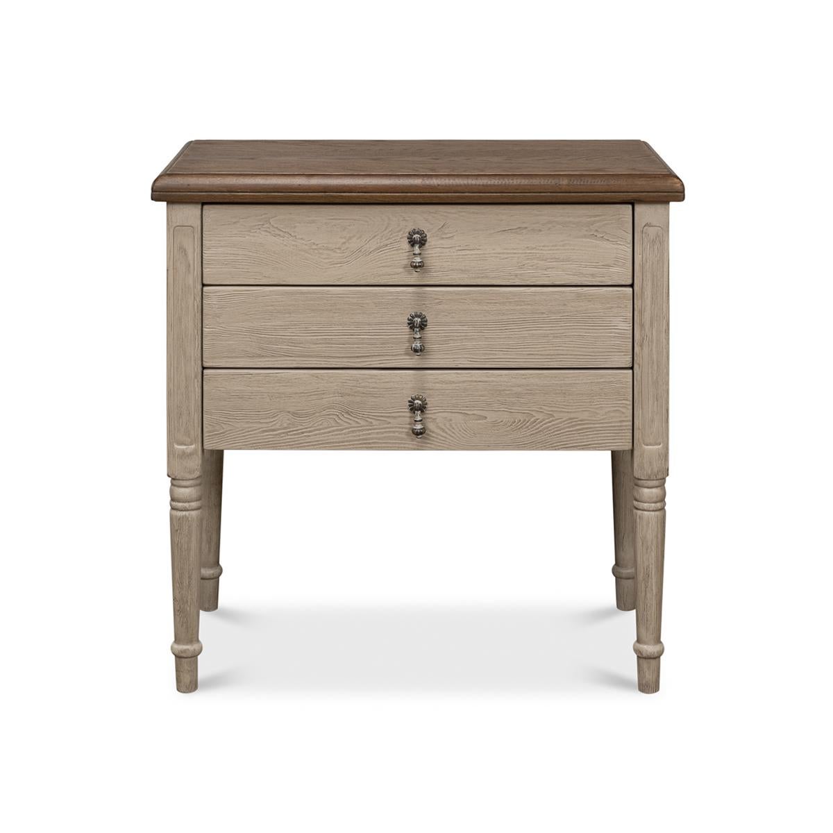 The perfect addition to any elegant and sophisticated bedroom or living space, this beautiful piece boasts a natural finish oak top with a molded edge, creating a sleek and refined look. The top is contrasted by a soft grey painted base that adds a