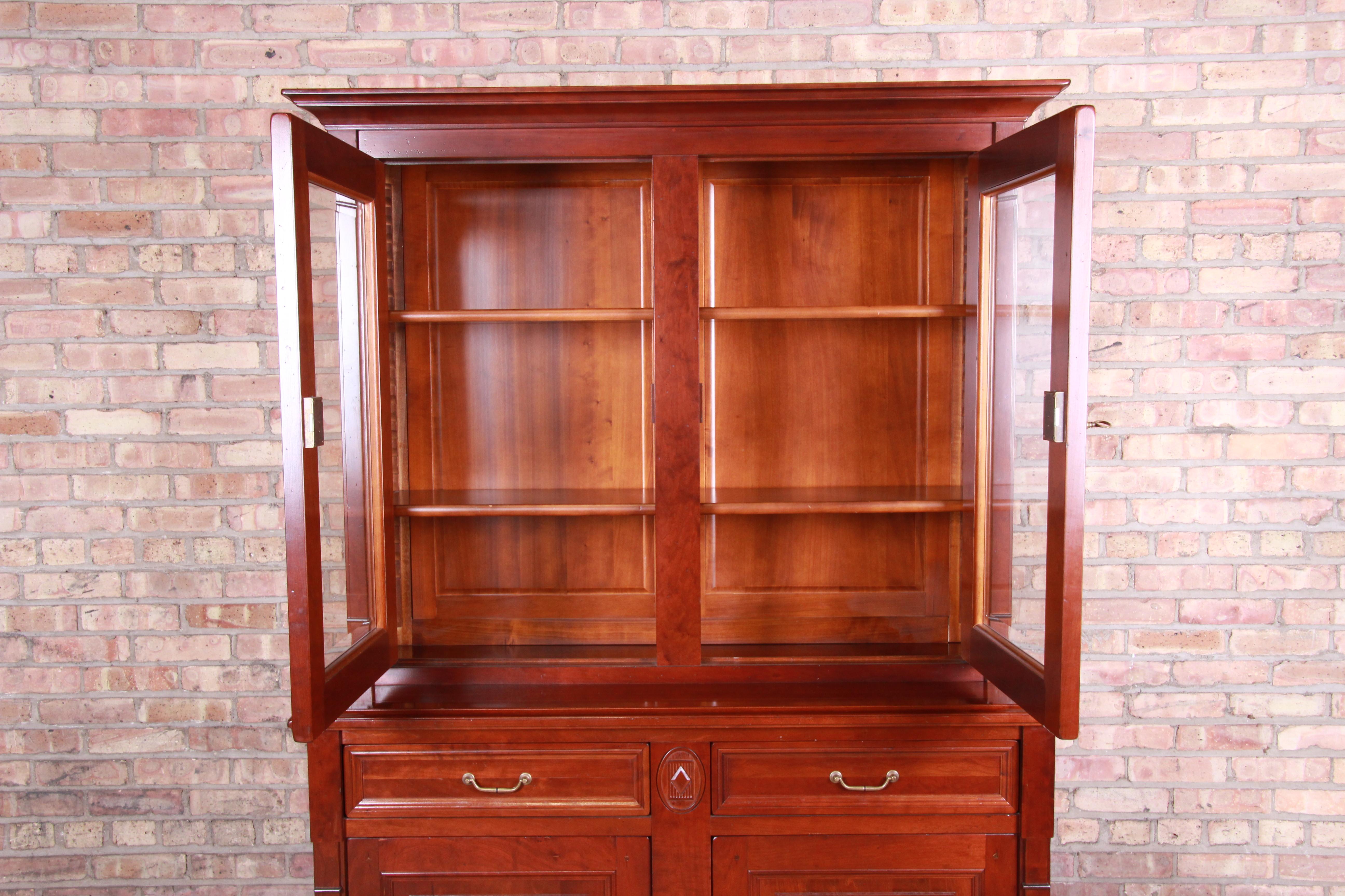 An exceptional French Country breakfront bookcase or sideboard bar cabinet

By Grange

France, early 21st century

Solid cherrywood, with brass hardware and accents.

Measures: 51.5