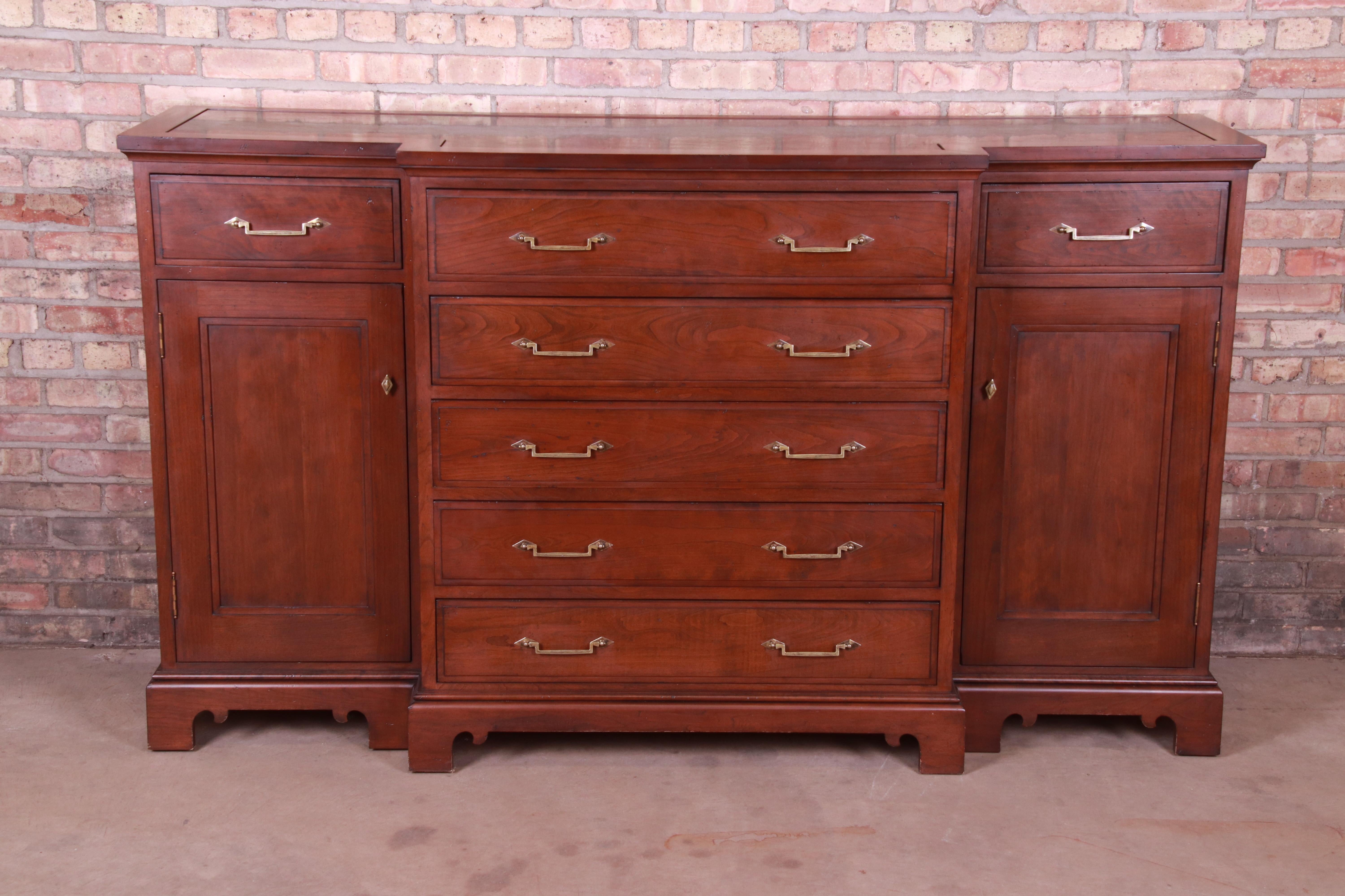 An exceptional French Provincial breakfront sideboard credenza or bar cabinet

Attributed to Grange

Late 20th century

Solid mahogany, with inset marble top, original brass hardware, and felt-lined drawers.

Measures: 74