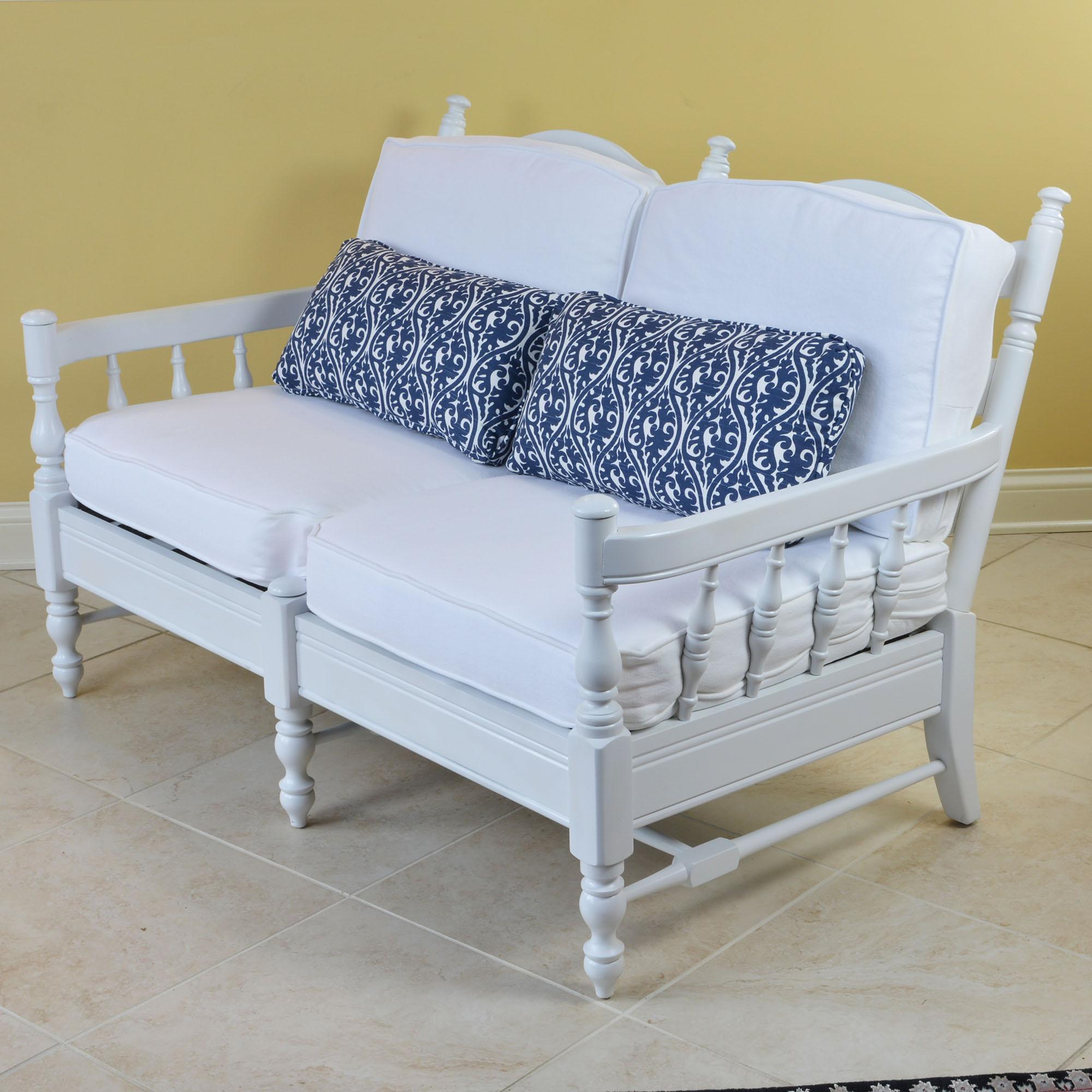 Newly updated French Provincial style settee is painted a fresh white with cushions covered in a heavy duty duck fabric in a clean white and two lumbar cushions in a coordinating navy/white print. This two person wood settee features triple ladder