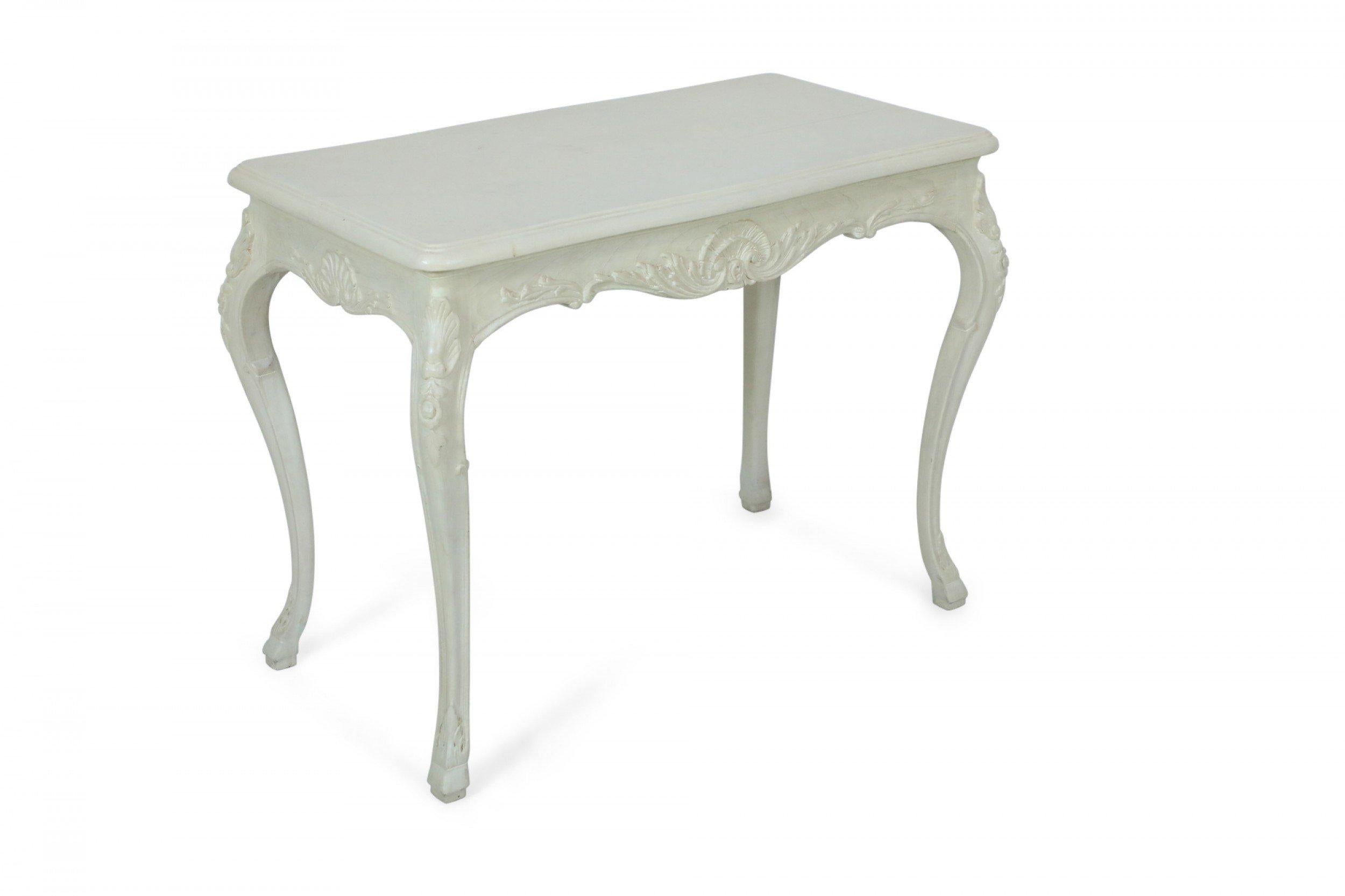 French Provincial Louis XV-style bleached wood white table desk with wrapped and painted canvas top, hidden center drawer, carved apron and serpentine legs

Condition: Good; Wear consistent with age and use