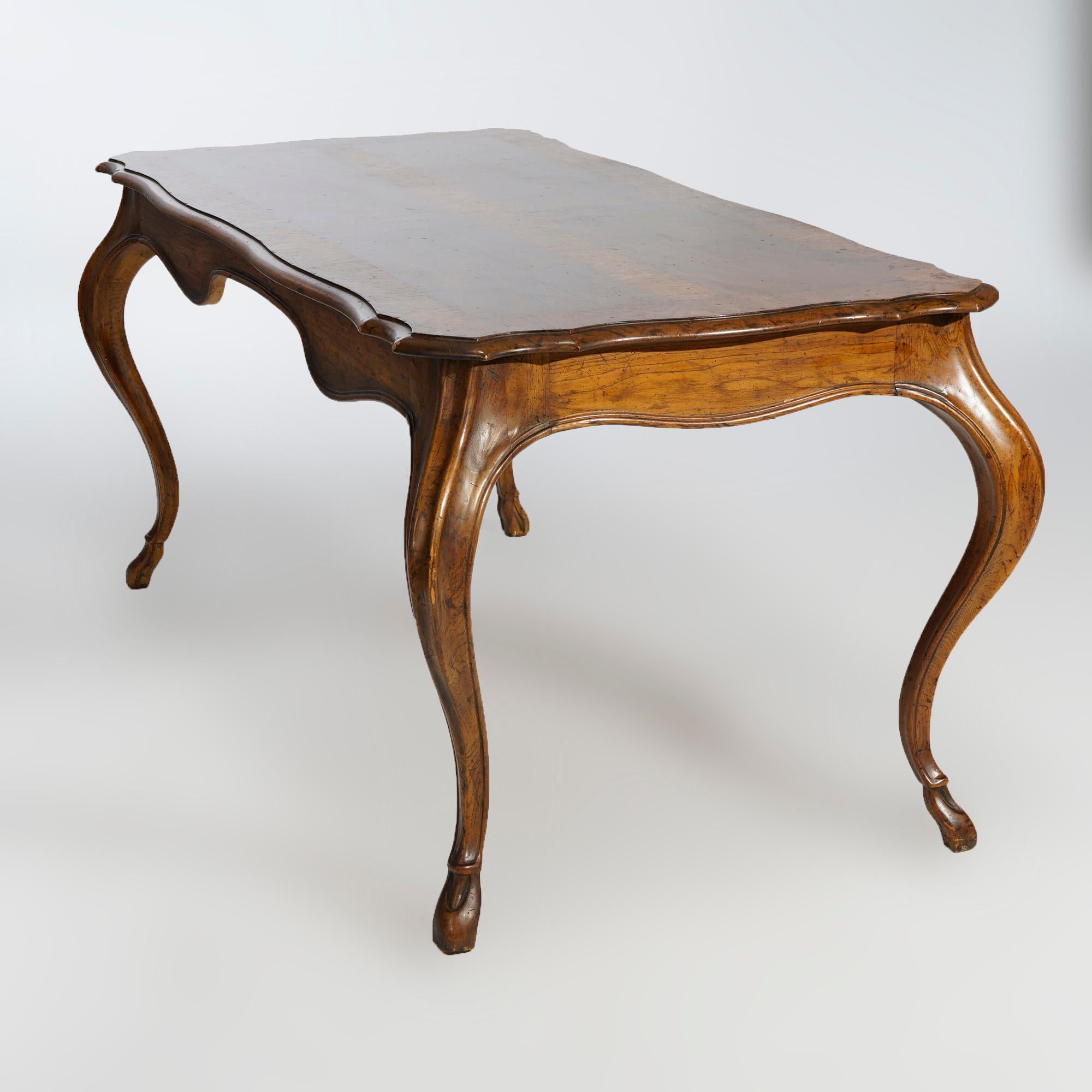 A French Provincial style writing desk by Heritage of the Grand Tour line offers walnut construction with shaped and beveled top having parquetry inlay over skirt with drawers, raised on cabriole legs terminating in stylized hoof feet, maker mark as