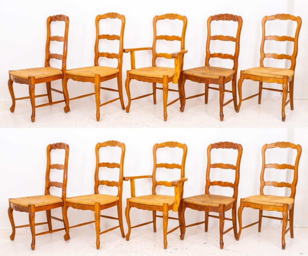 French provincial style dining chairs, an assembled set of ten (10), and comprising eight side chairs and two arm chairs, each with floral-craved ladder backs above a rush-woven seat on a curving seat rail above four cabriole legs. 40.5