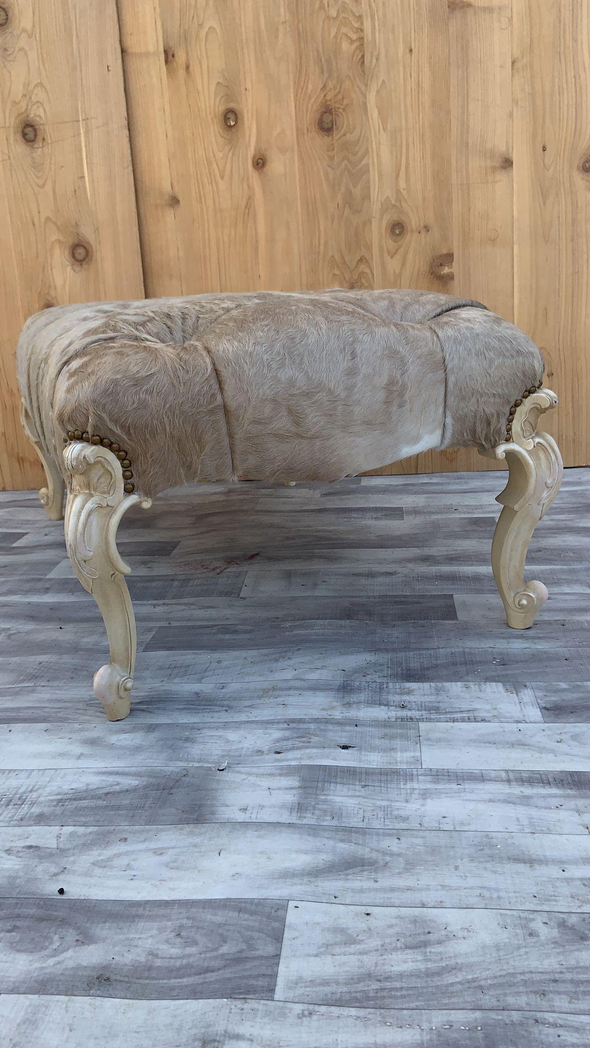 Vintage French Provincial Style Ottoman with Hand Carved Cabriole Legs Newly Upholstery in a Brazilian Cowhide “Cafe Latte” Color

Beautiful French Provincial style ottoman with a cream painted ornate hand carved scrolled detailed cabriole legs. The