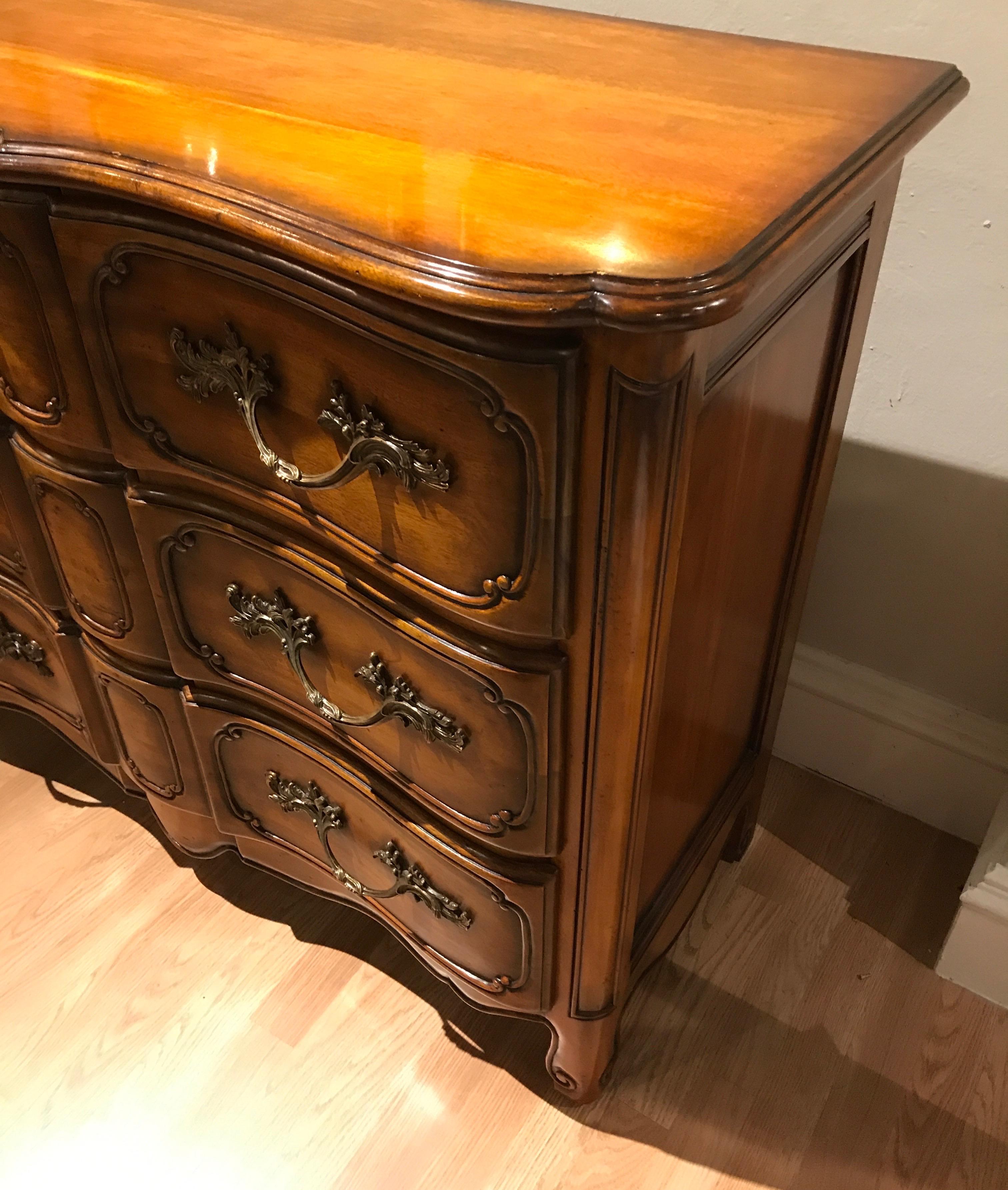 Finely made French Provincial style three-drawer commode with large bronze pulls. Wonderful attention to detail.