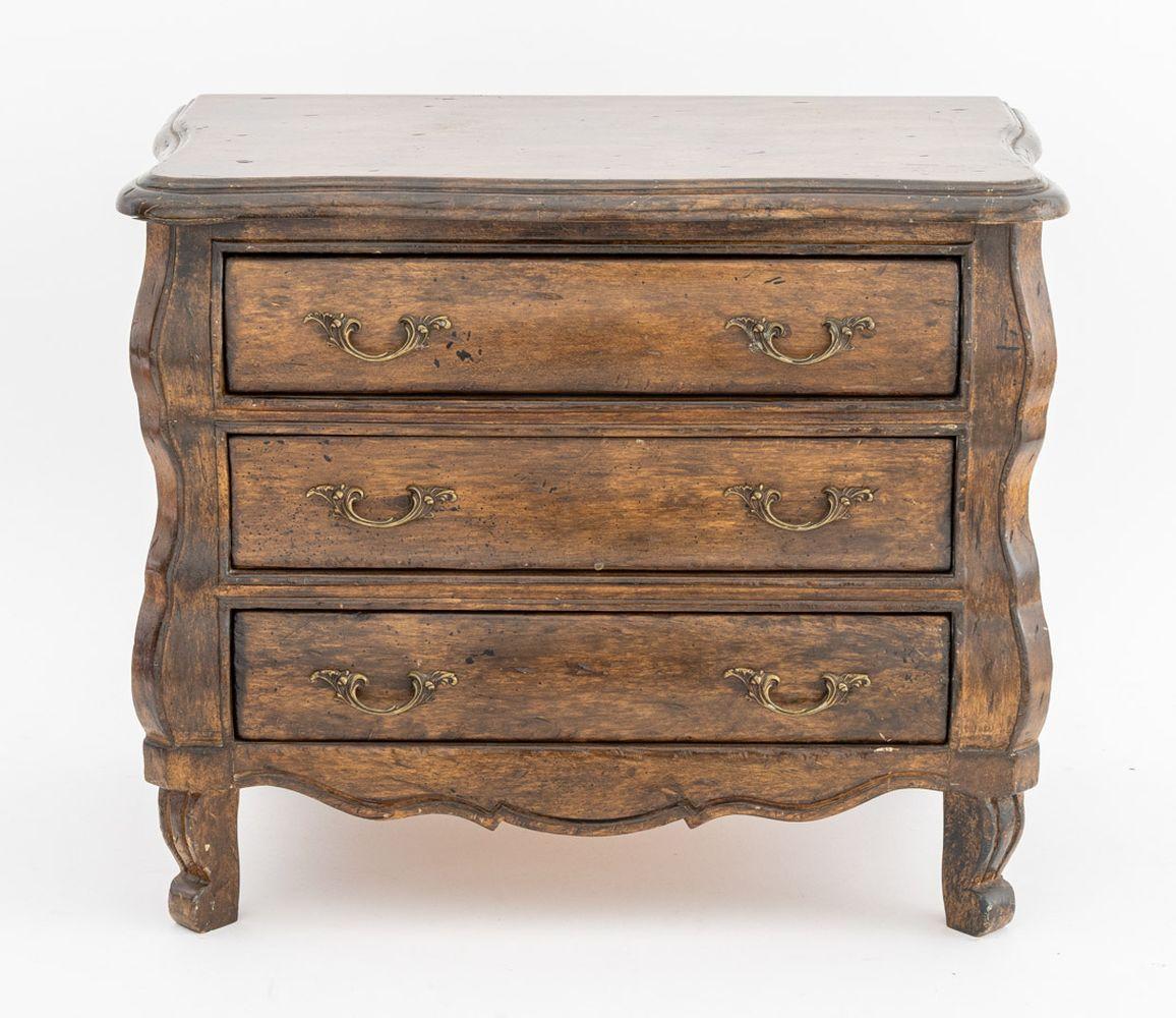French Provincial Style Walnut Miniature Commode, early 20th century, with three drawers and brass pulls on four cabriole legs. 17