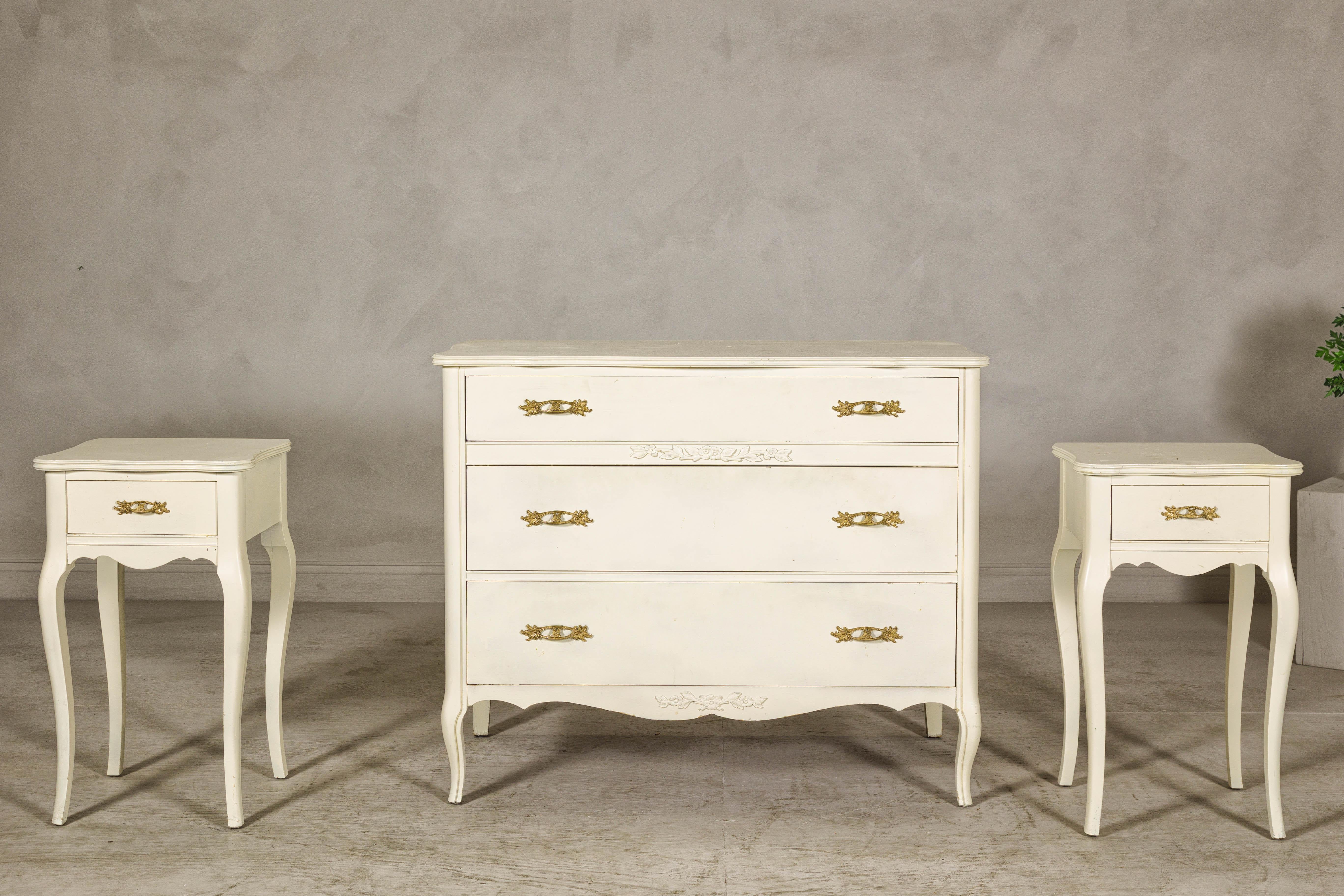 The West Michigan dresser and matching pair of nightstands bring French Provincial charm to your home with their soft cream finish and graceful details. Crafted from solid hardwood and accented with delicate carvings and cabriole legs, this vintage