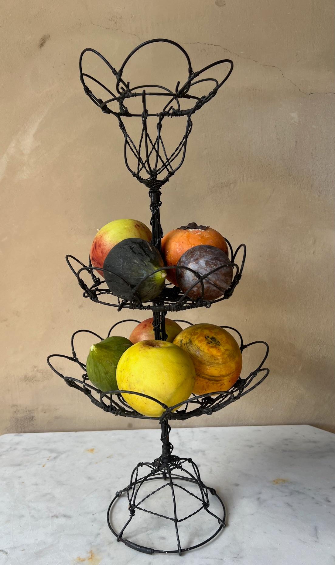 Triple tier standing basket made in France around 1920. Hand made by twisting wires, originally used in Provence for holding fresh eggs, vegetables and fruit. 
