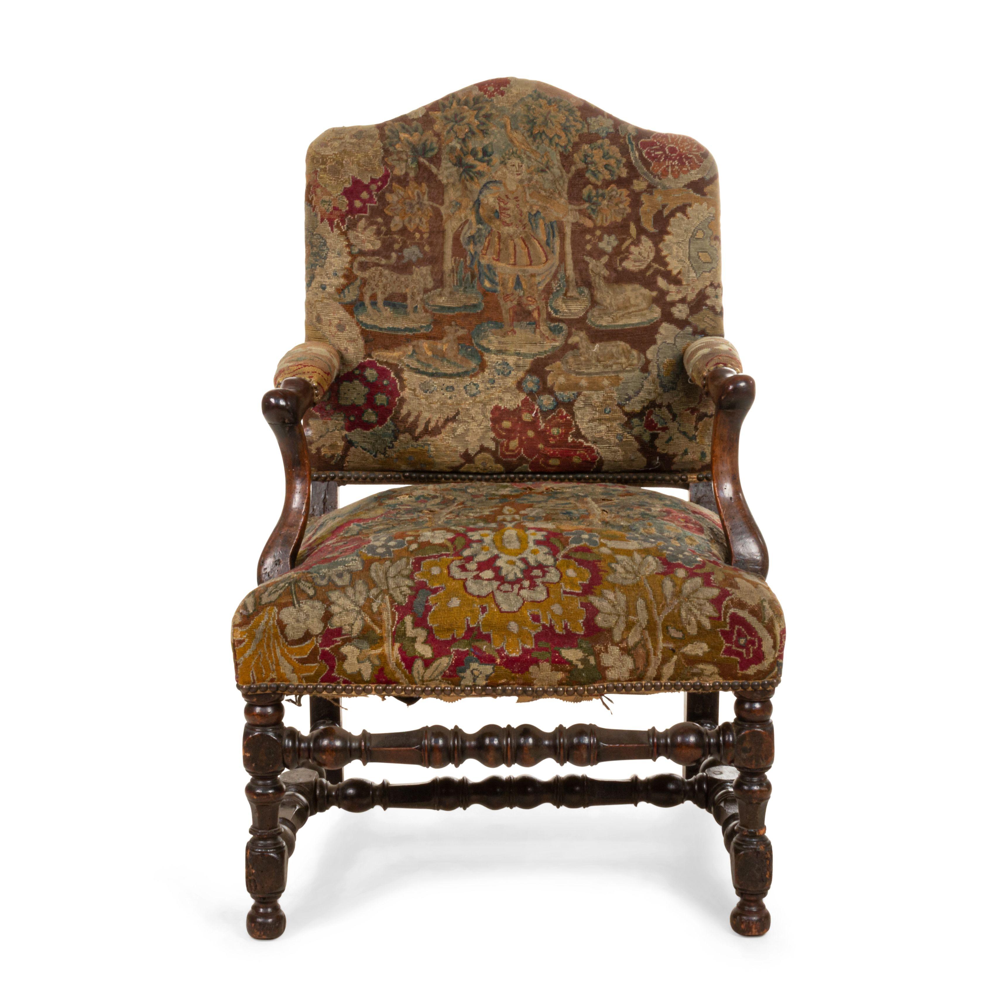French Provincial (18th century) walnut open armchair with needlepoint upholstery and turned legs and stretcher.