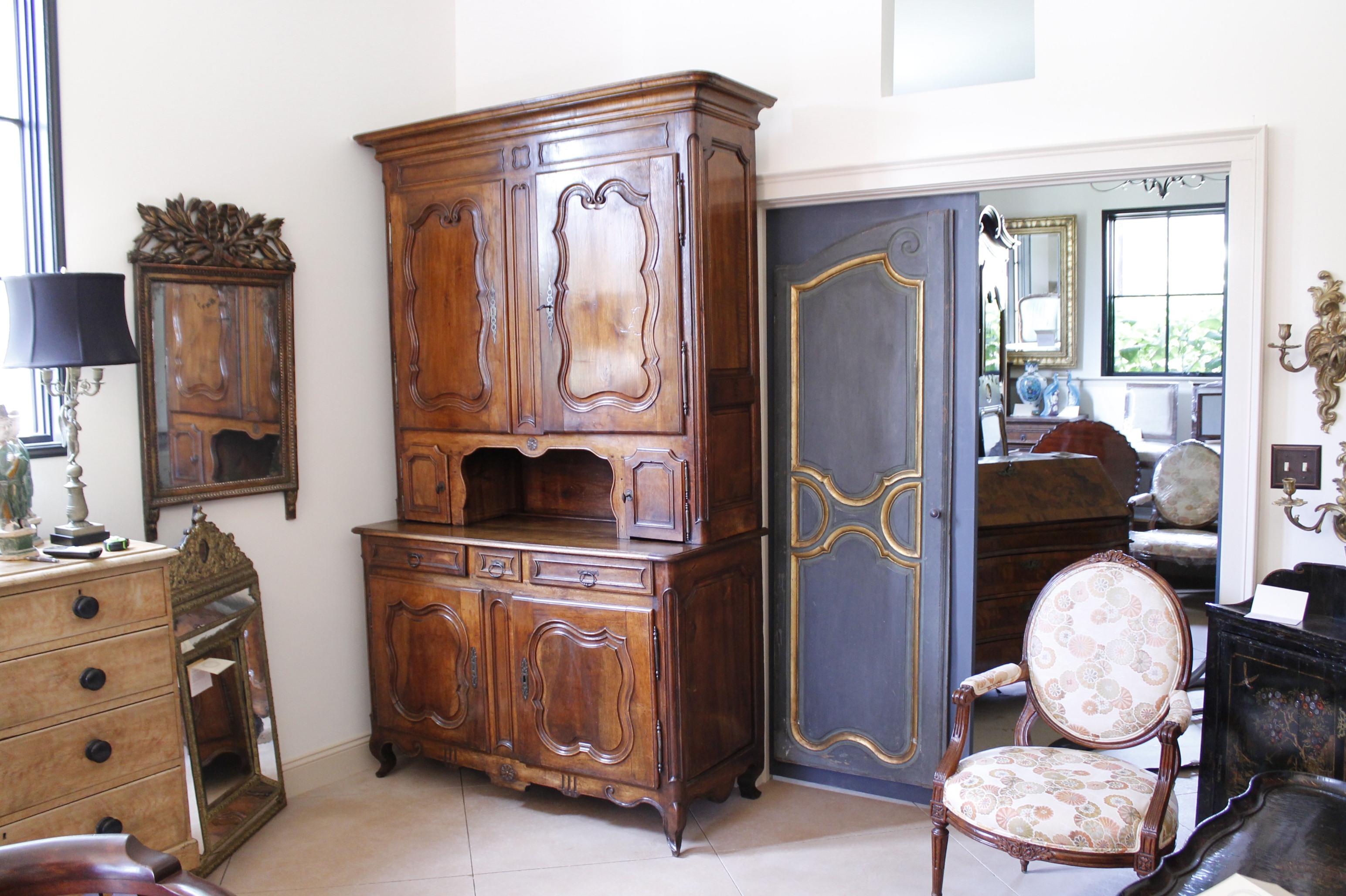 A large and very handsome buffet à deux corps, traditional French two part cupboard. The cabinet below is fitted with one sturdy shelf while the multi-compartmented top portion is fitted for adjustable shelving. The interior of the upper case has