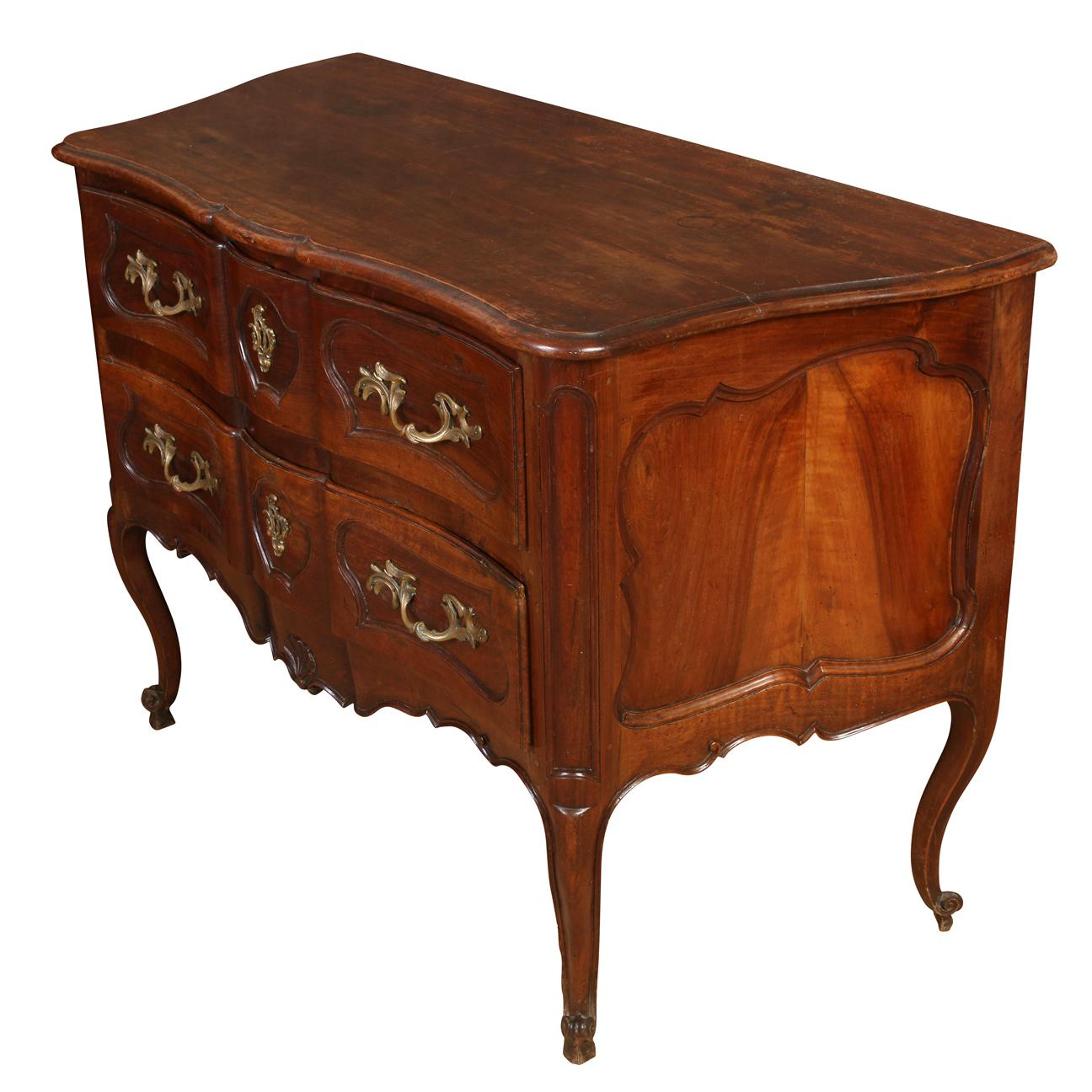 Antique French walnut two drawer commode with gilt metal mounts and hardware, carved, curved legs and shaped top.