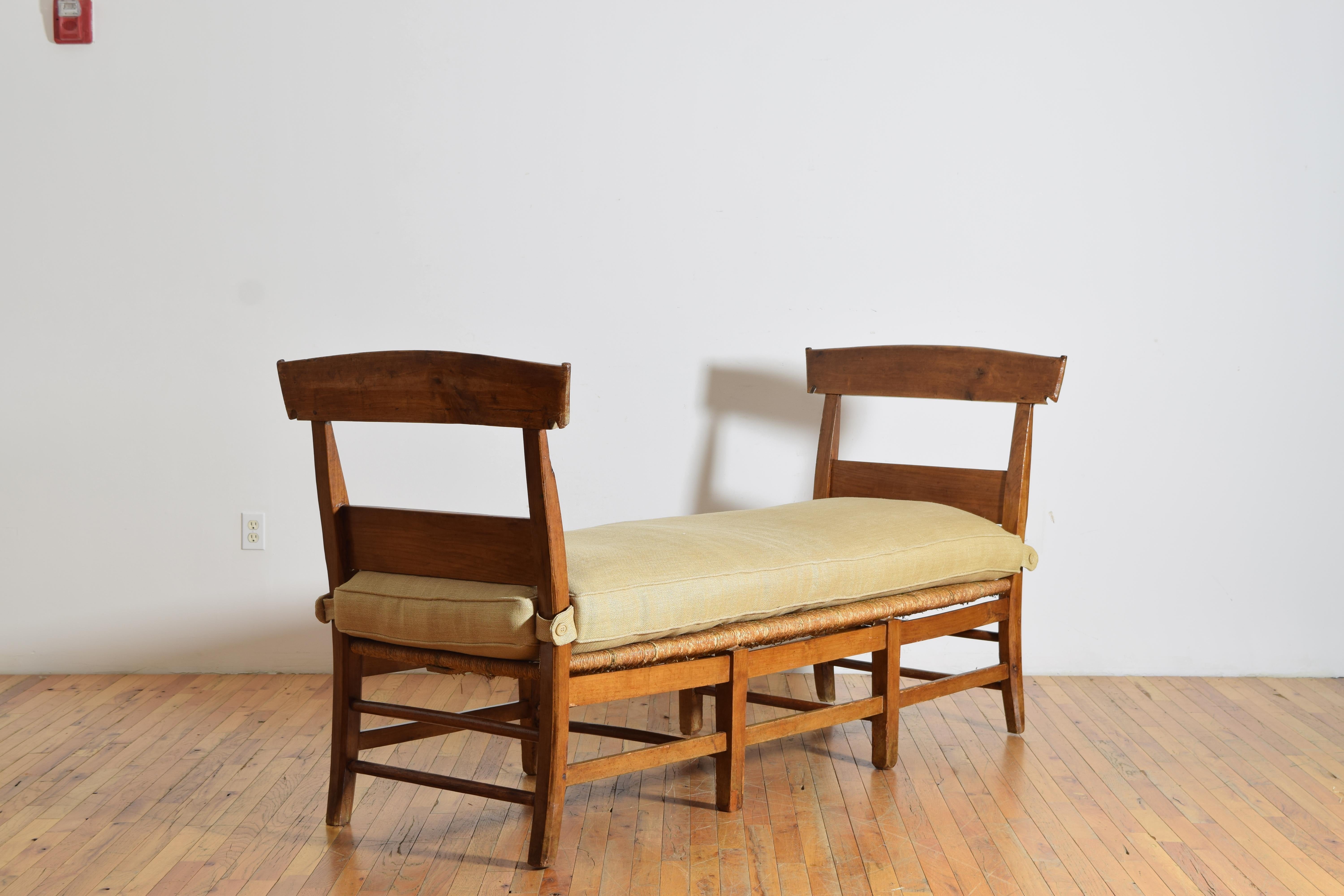 a large scale French Provincial bench with walnut frame and rush seat, topped with a removable custom linen cushion, seat height without cushion is 16.25