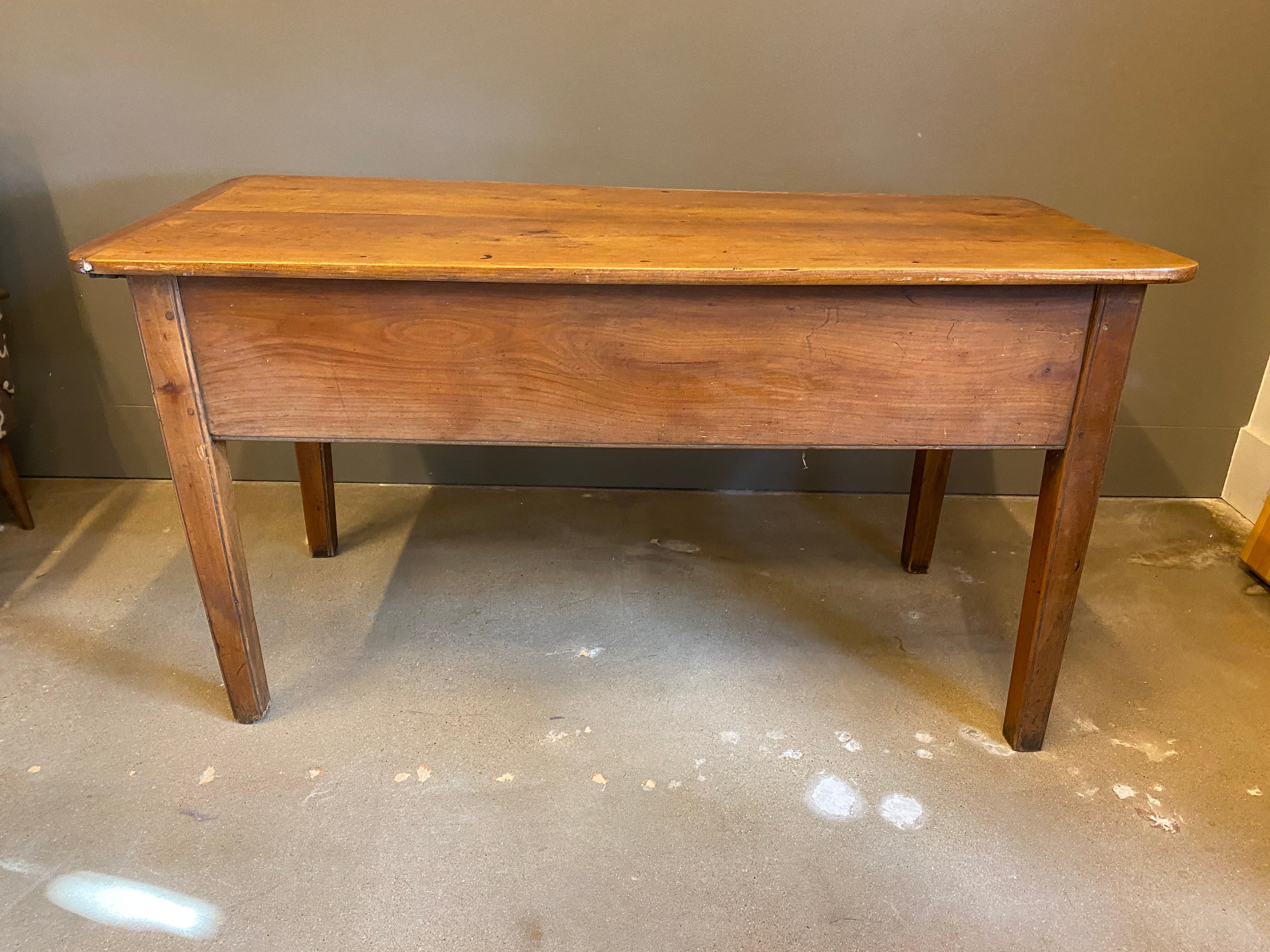 French Provincial fruitwood work table or console table, 19th c., rectangular top, over two drawers to front and side, rising on tapered legs.