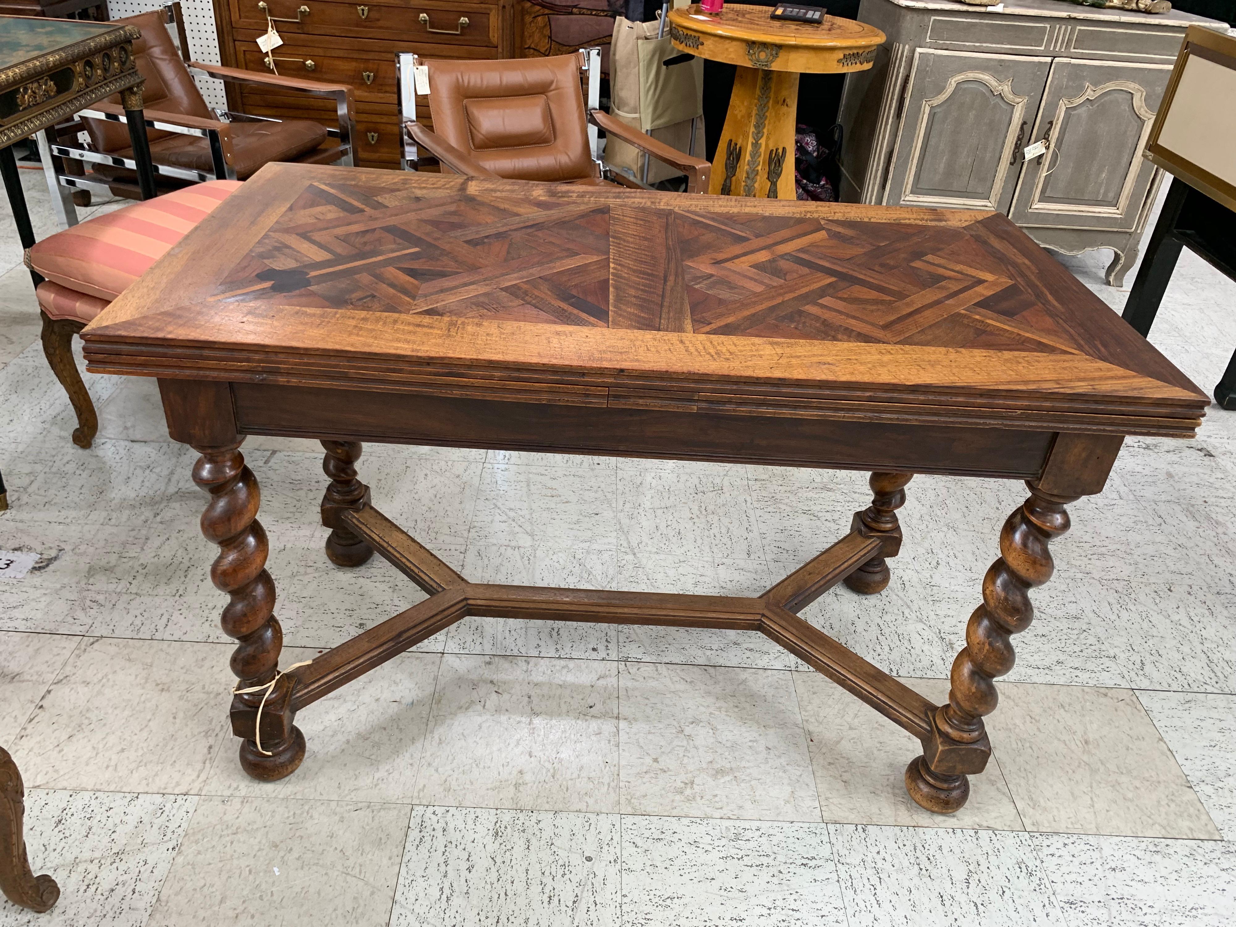 French walnut pull out leaves table standing on barley twist legs and stretcher.
It could be used as a sofa table, desk or dining table. 
The 2 leaves are 21 1/2 in. long which makes the length with leaves pulled out 90 inches