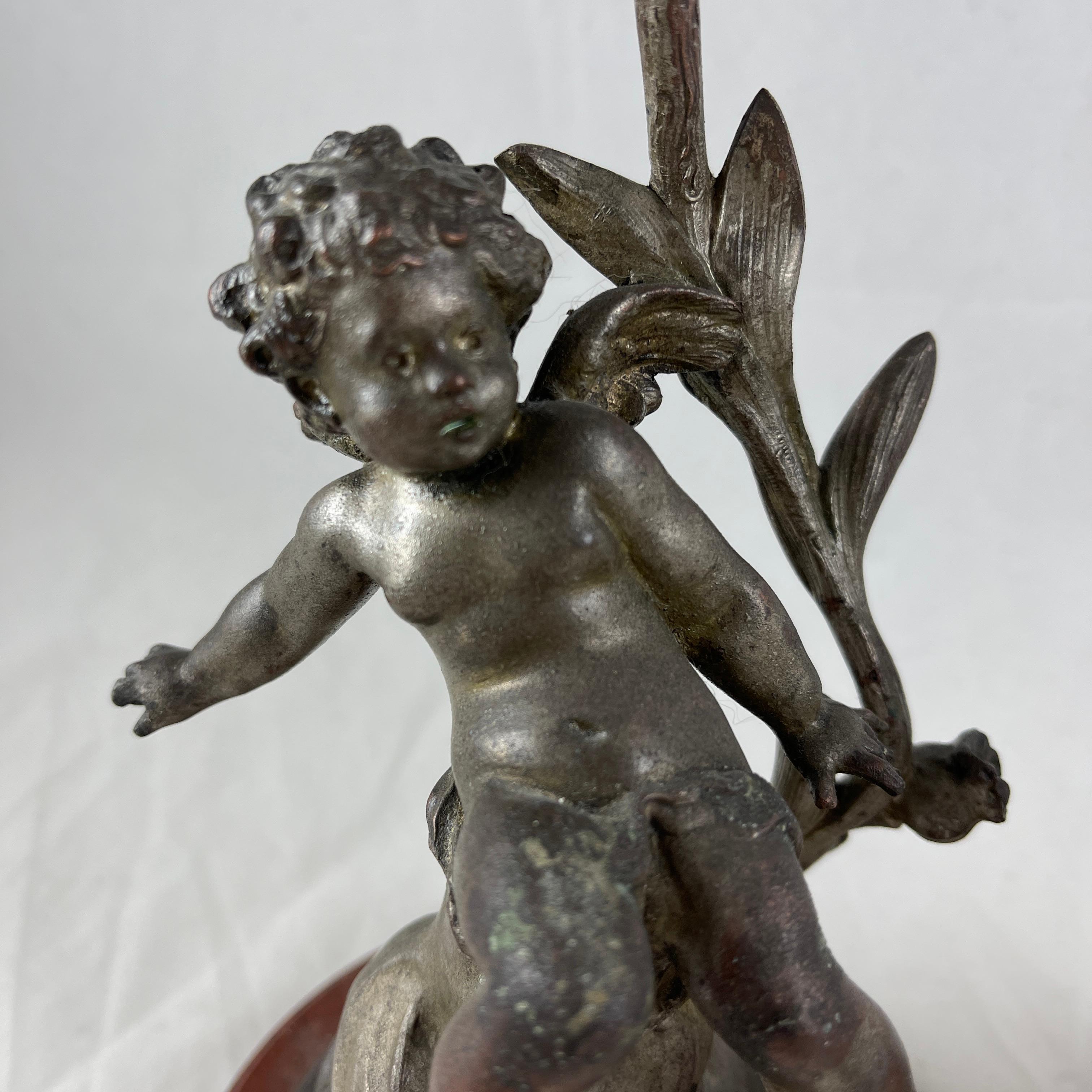 A charming and heavy pair of Putti candlesticks modeled and signed by the French sculptor Sylvain Kinsburger. The pair are modeled with great detail and a sense of fluid movement, circa late 19th century.

Showing two different putto or cherub