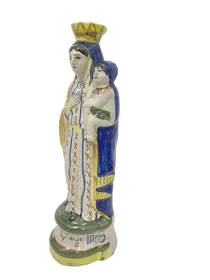 French Quimper pottery, Madonna with child, ca 1900

A Quimper pottery statue of Madonna and Child, marked with the mark HB, used from 1883-1904, France. With text Saint Vierge at the edge of the base, meaning Saint Mary. The statue shows signs of