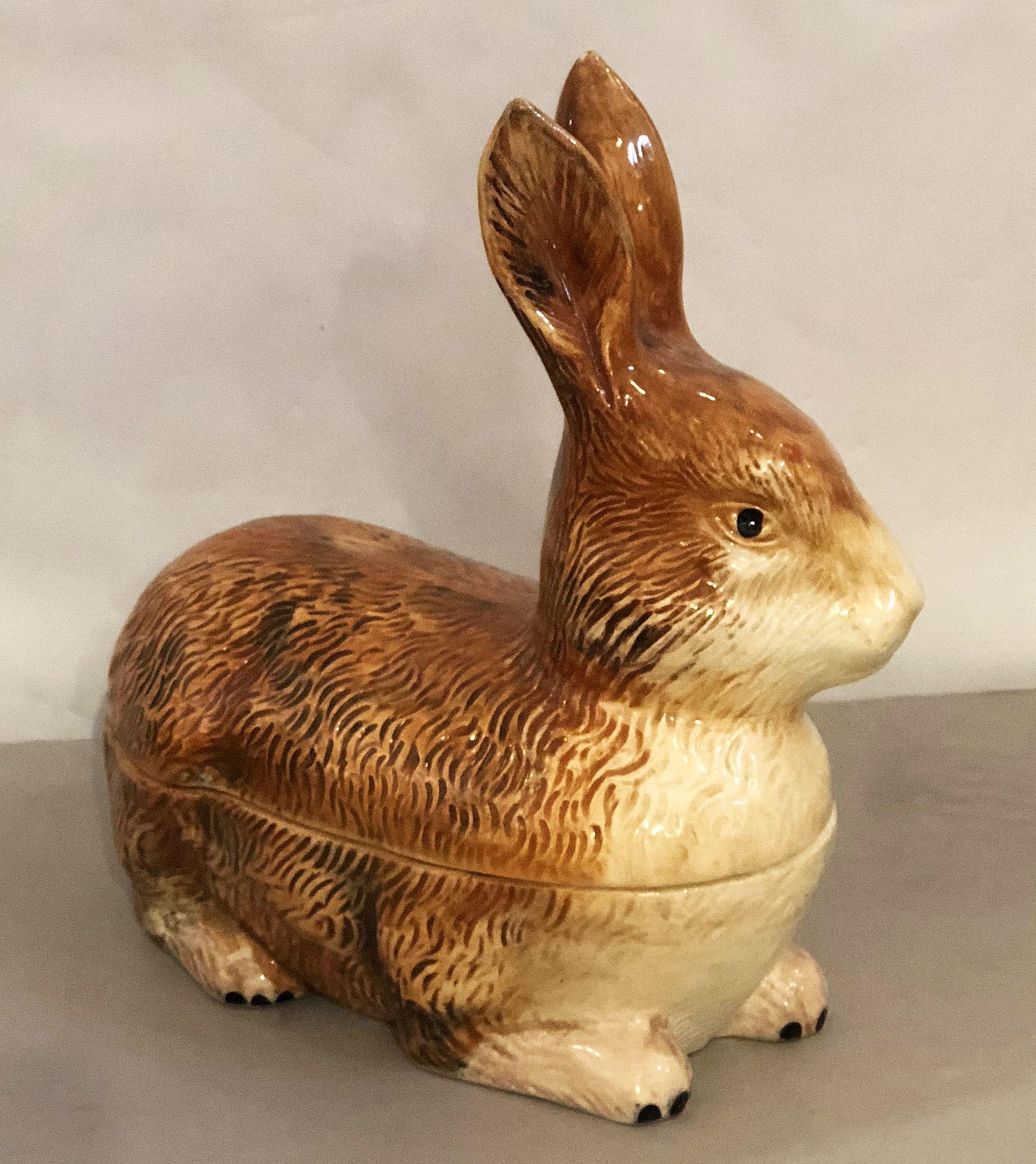 A fine French faience pâté terrine or tureen with lid and under tray in the shape of a rabbit by Michel Caugant.

Caugant signature on bottom.

 