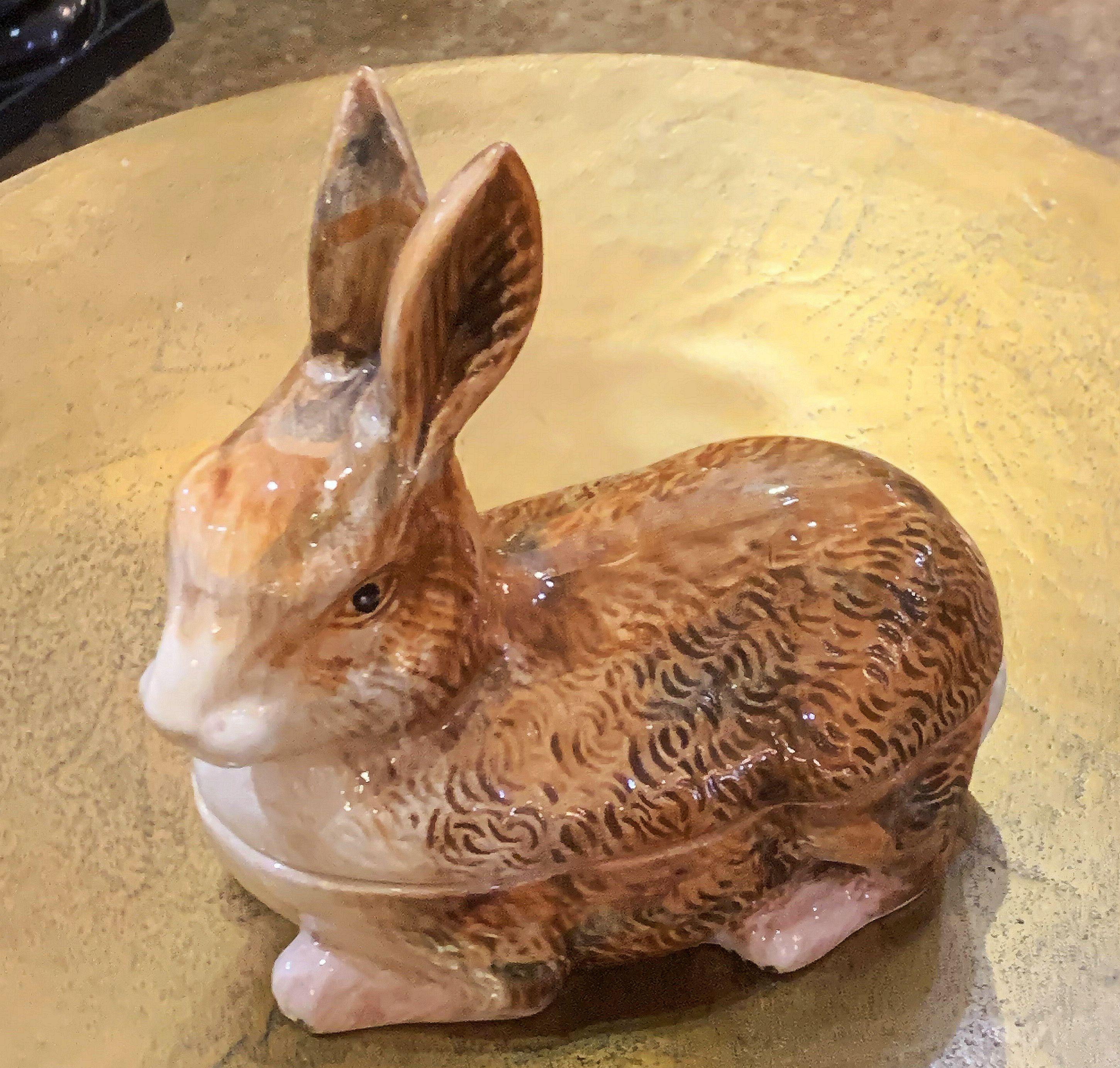 A fine French faience tureen ( pâté terrine) with lid and under tray in the shape of a rabbit by Michel Caugant.

Caugant signature on bottom.

