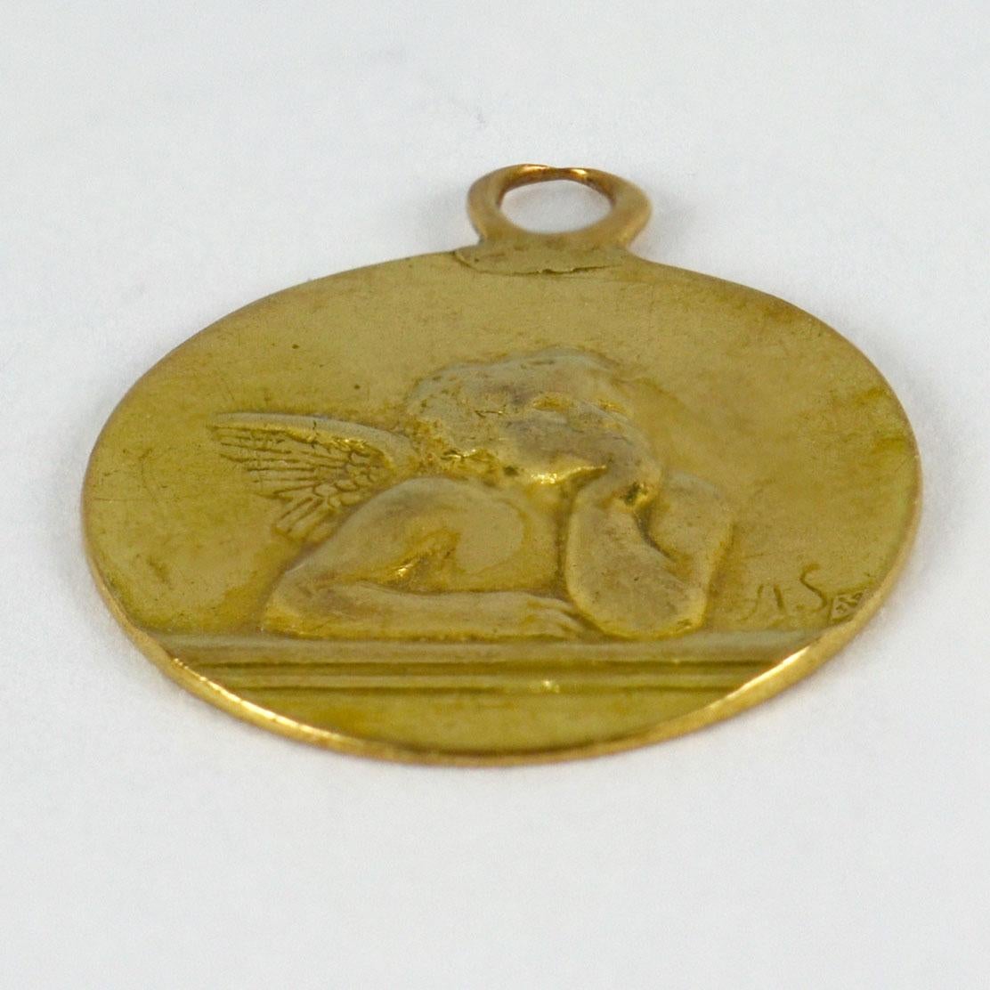 An 18 karat (18K) yellow gold charm pendant designed as a medal depicting Rafael’s cherub. Signed A.S., stamped with the eagle’s head for French manufacture and 18 karat gold, with unknown maker’s mark.

Dimensions: 2 x 1.7 x 0.13 cm (not including
