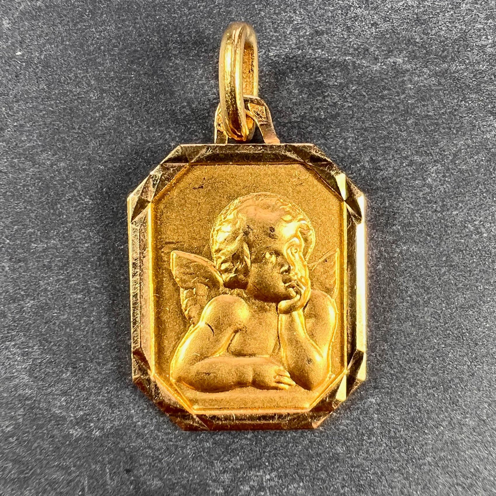A French 18 karat (18K) yellow gold charm pendant designed as a rectangular medal depicting Rafael’s cherub within a faceted frame. Stamped with the eagle mark for 18 karat gold and French manufacture with an unknown maker's mark.  

Dimensions: 1.9