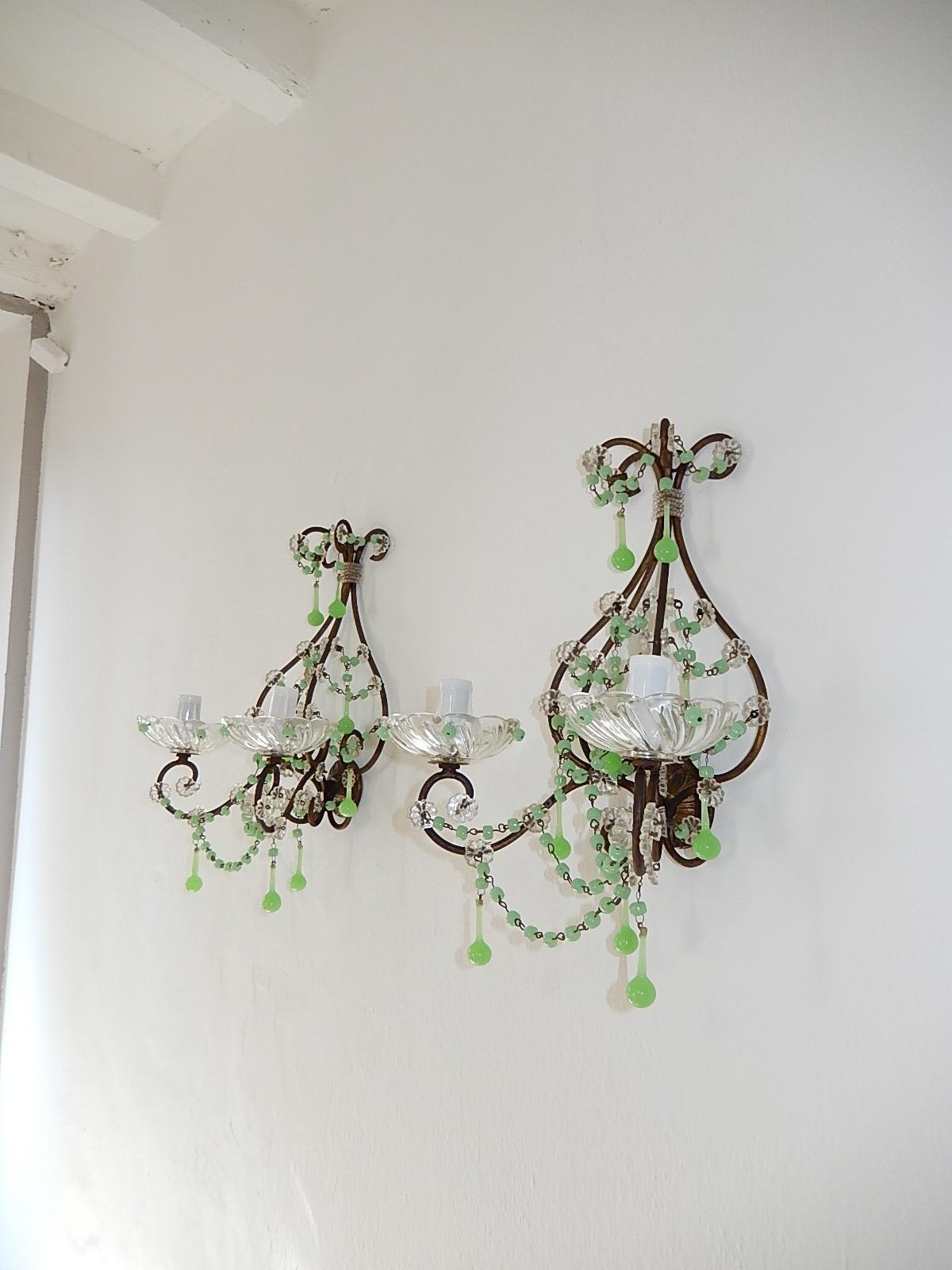 Housing two lights each. Will be rewired with certified US UL sockets for the USA and appropriate sockets for all other countries and ready to hang!  Rare swirled bobeches with green opaline beads. Adorning florets with swags of green opaline beads